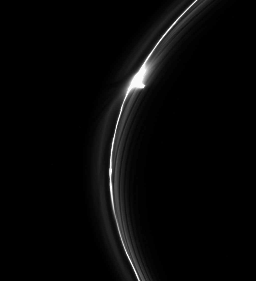 Saturn's dynamic F ring backlit by the sun. The rings take on surprising textures, thanks to the eddies in their orbits and the interacting gravity of the small and large pieces of debris that make up the rings. In this image, features astronomers call gores and jets—which look pretty much as their names suggest—are visible.