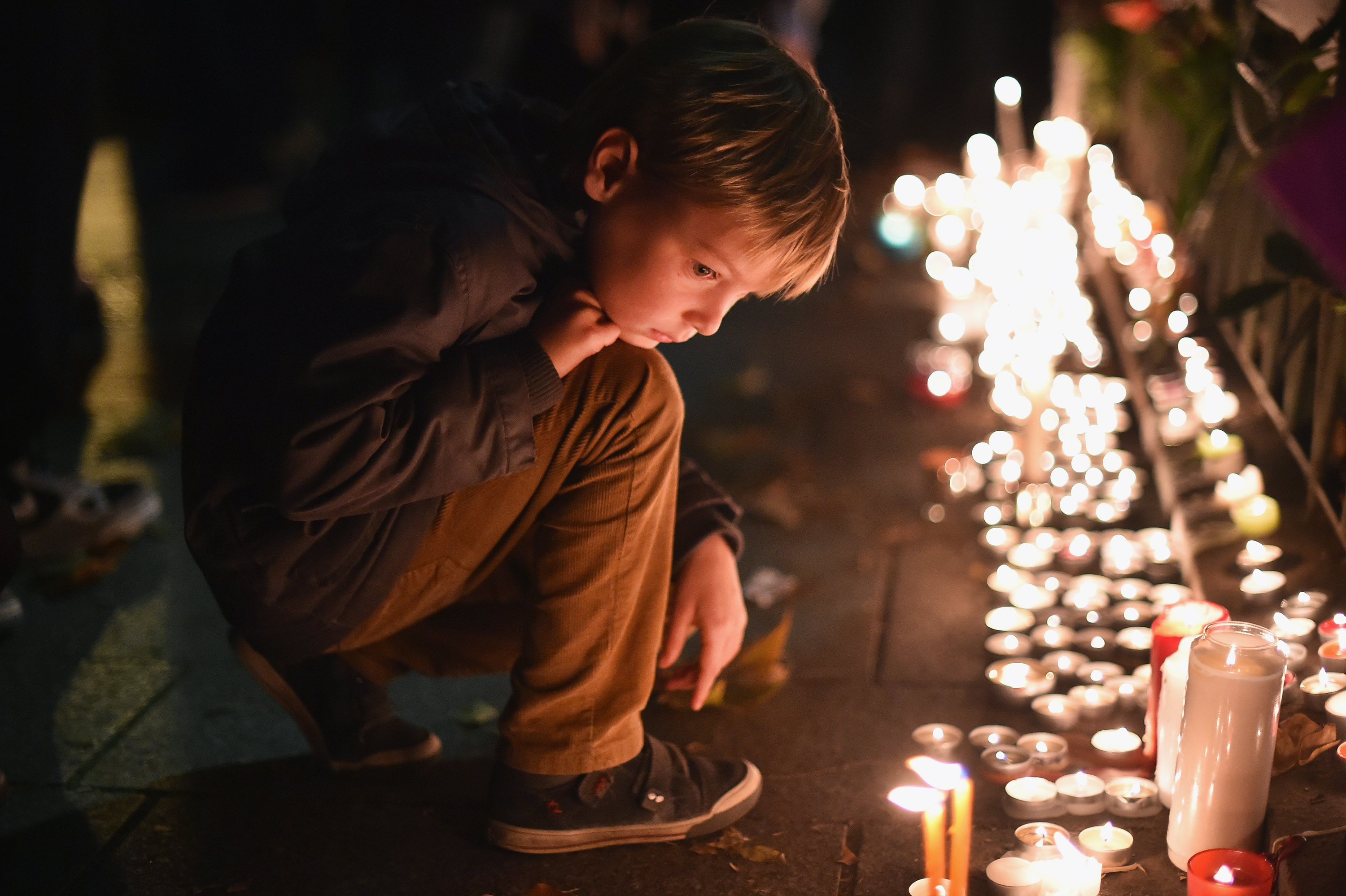 A young boy views tributes following terrorist attacks in Paris, on Nov. 16, 2015. (Jeff J Mitchell—Getty Images)