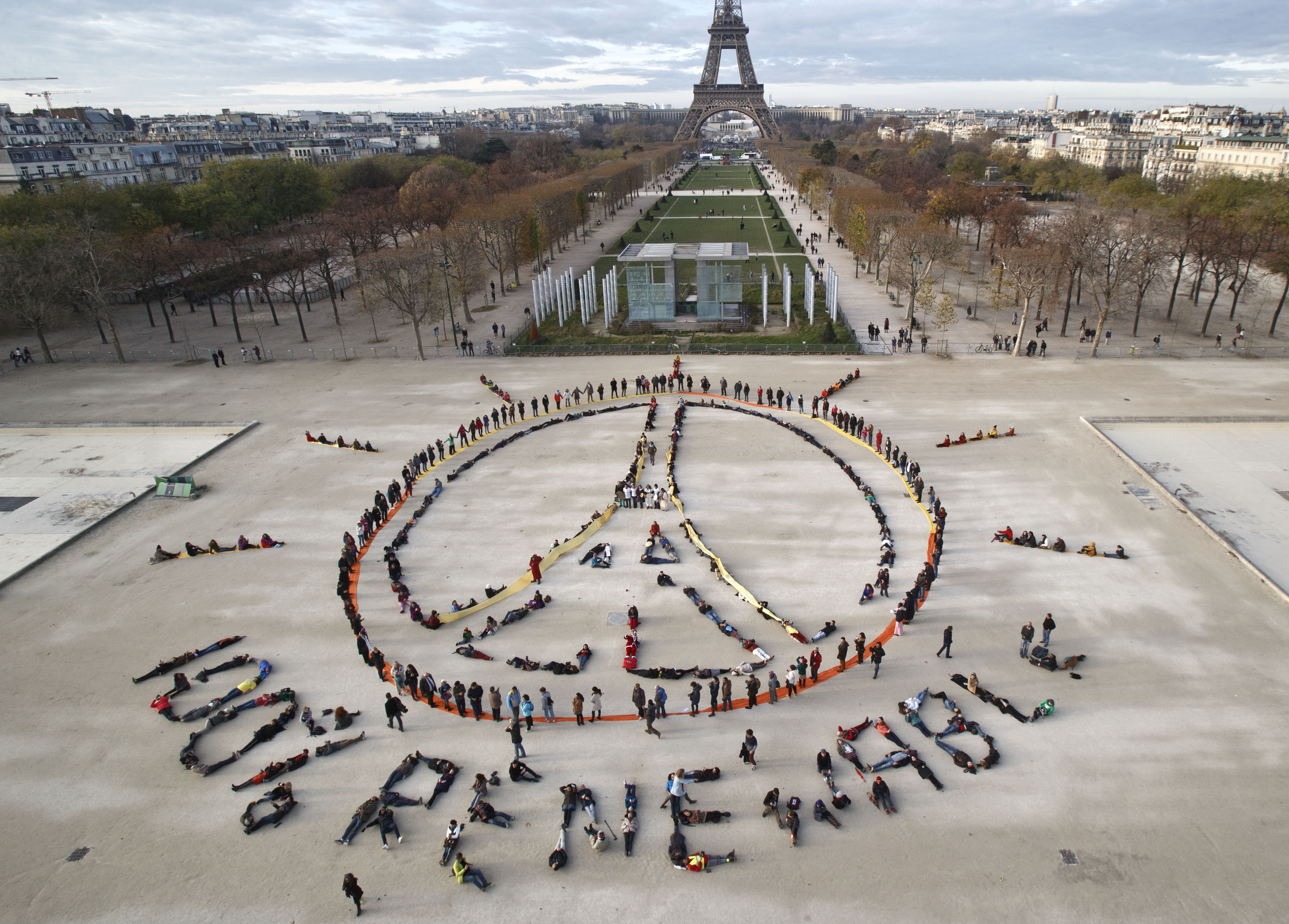 Environmentalist activists form a human chain representing the peace sign and the spelling out "100% renewable", on the side line of the COP21, United Nations Climate Change Conference near the Eiffel Tower in Paris on Dec. 6, 2015. (Michel Euler—AP)