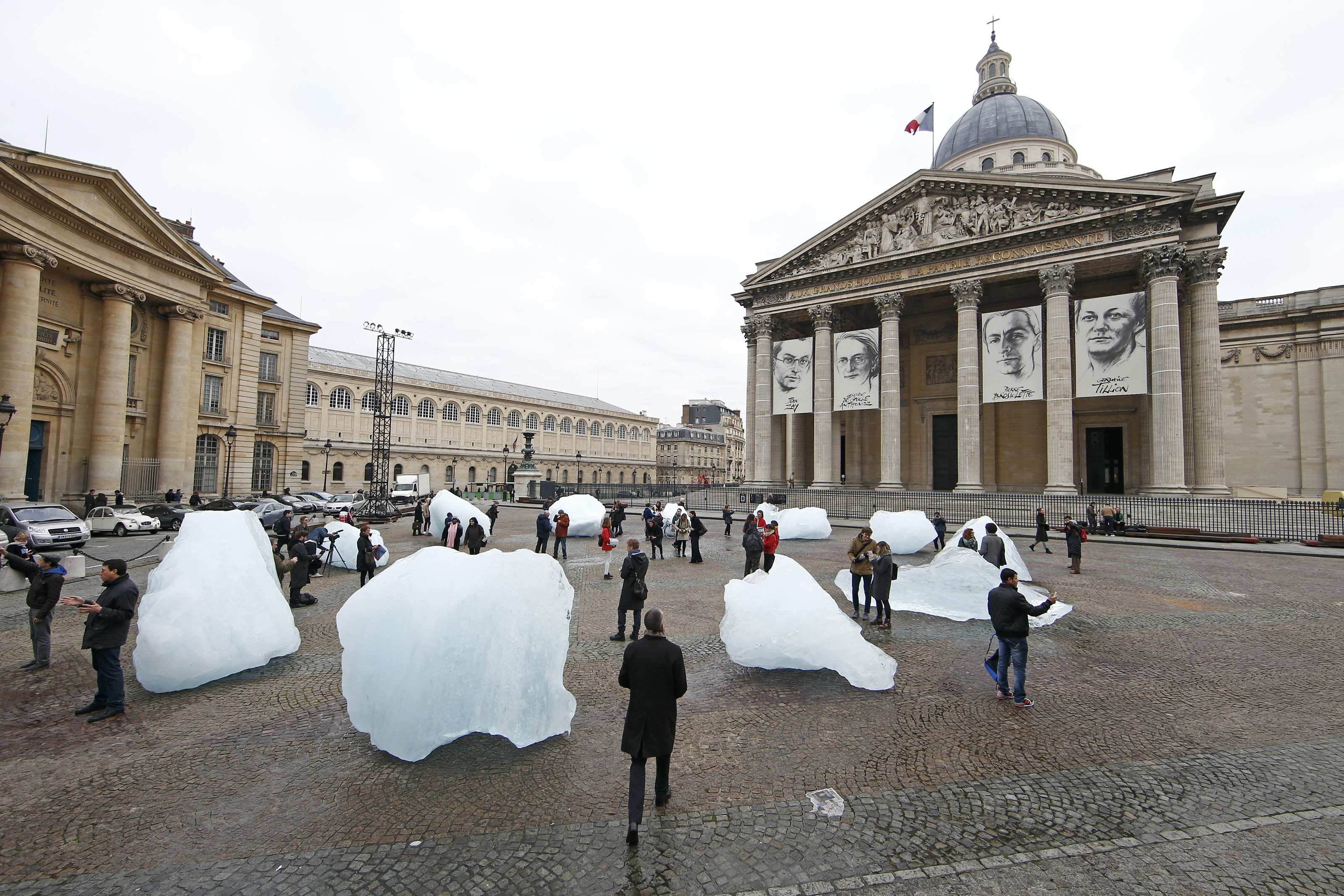 Visitors walk through ice blocks from Greenland installed on the Place du Pantheon for a project called Ice Watch Paris