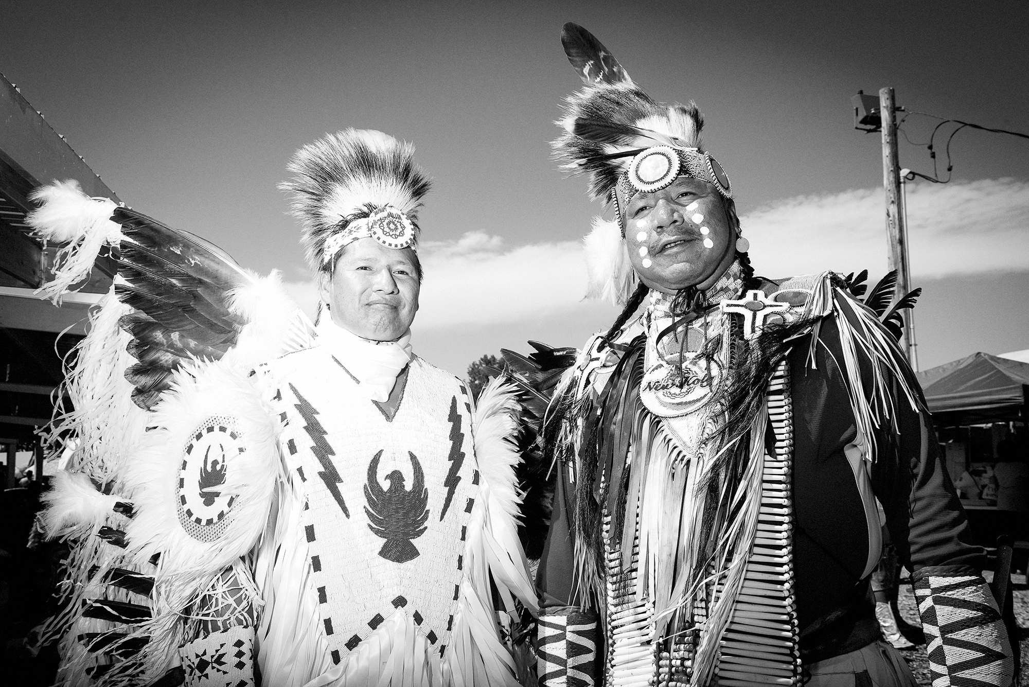 Two adult Lakota are seen at a pow wow at the Pine Ridge Reservation.