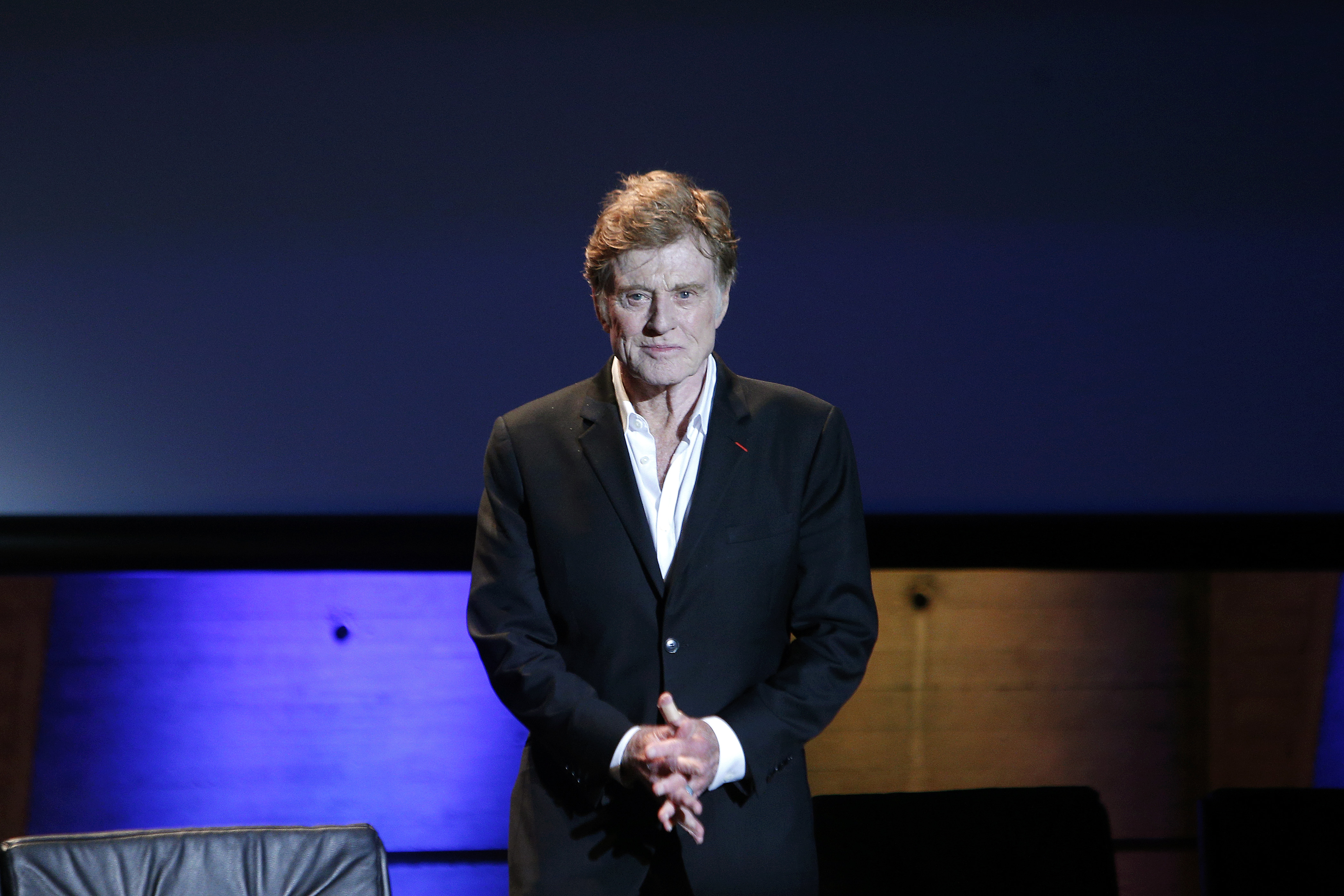 Robert Redford arrives on stage during a conference on climate at the UNESCO headquarters in Paris on Dec. 6, 2015. (Thibault Camus—AP)