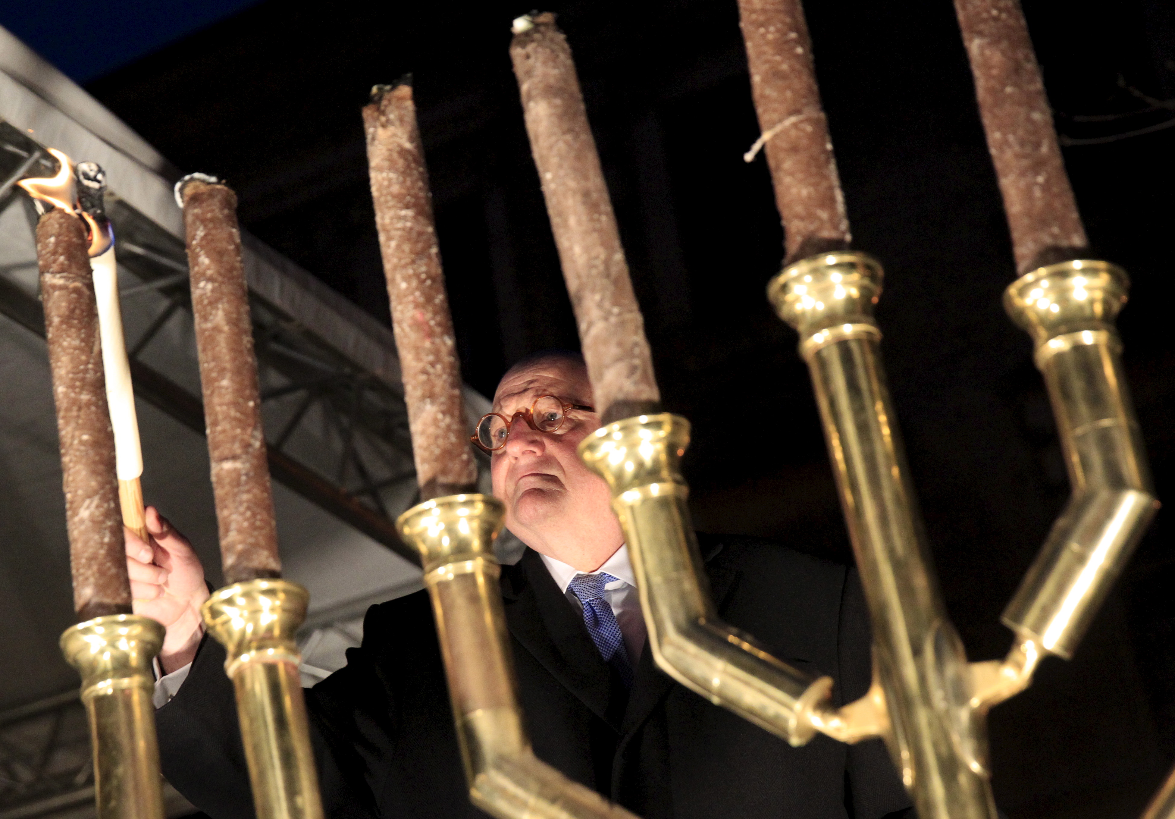 Ira Forman, U.S. special envoy of the Office to Monitor and Combat Anti-Semitism, lights a menorah during a protest organized by a Jewish group against a planned statue of Balint Homan in Szekesfehervar, Hungary, on Dec. 13, 2015 (Bernadett Szabo—Reuters)
