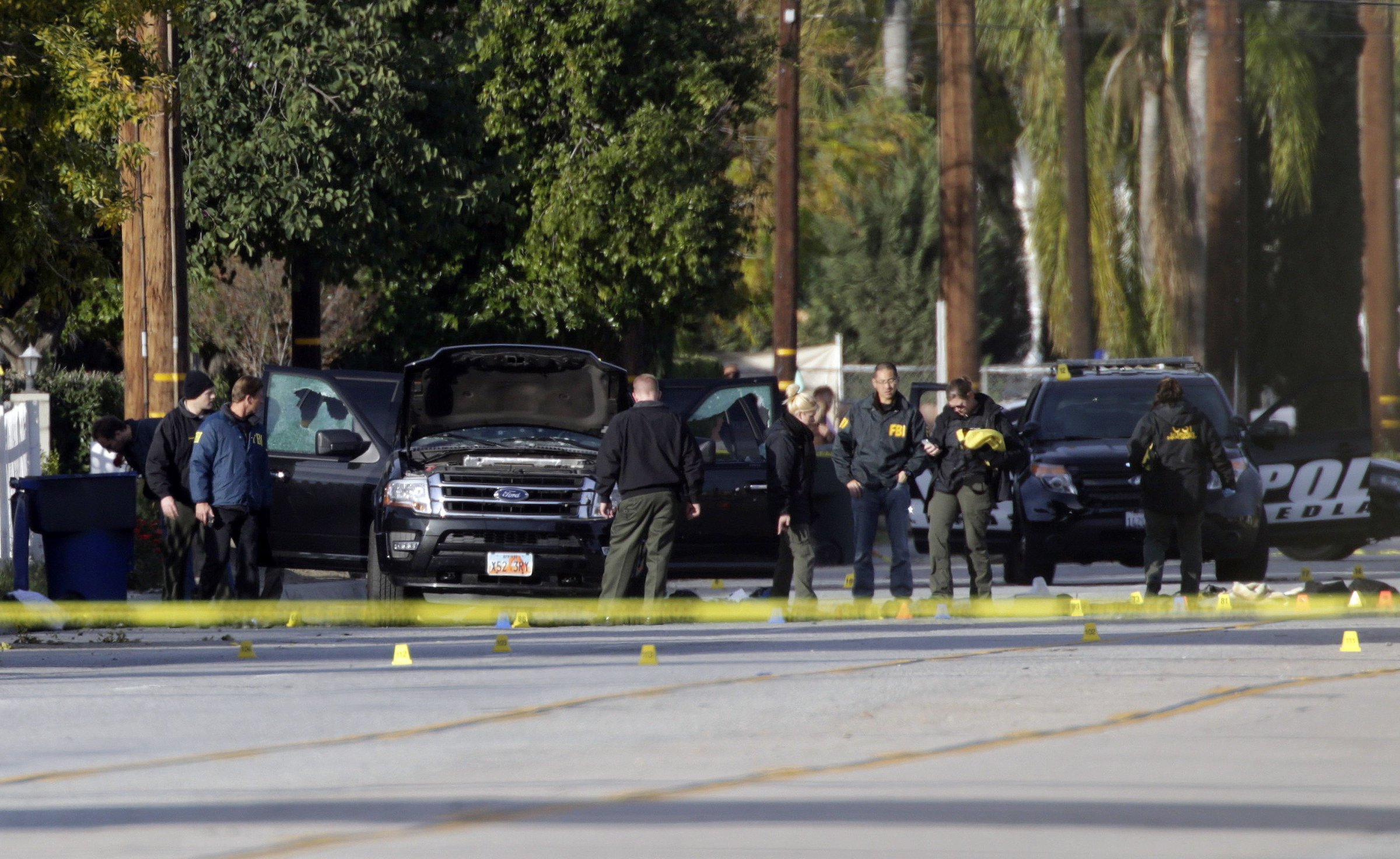 Law enforcement personnel continue to investigate on San Bernardino Avenue, where two suspects in the mass shooting at the Inland Regional Center died in a shootout with police in San Bernardino, Calif. on Dec. 3, 2015.