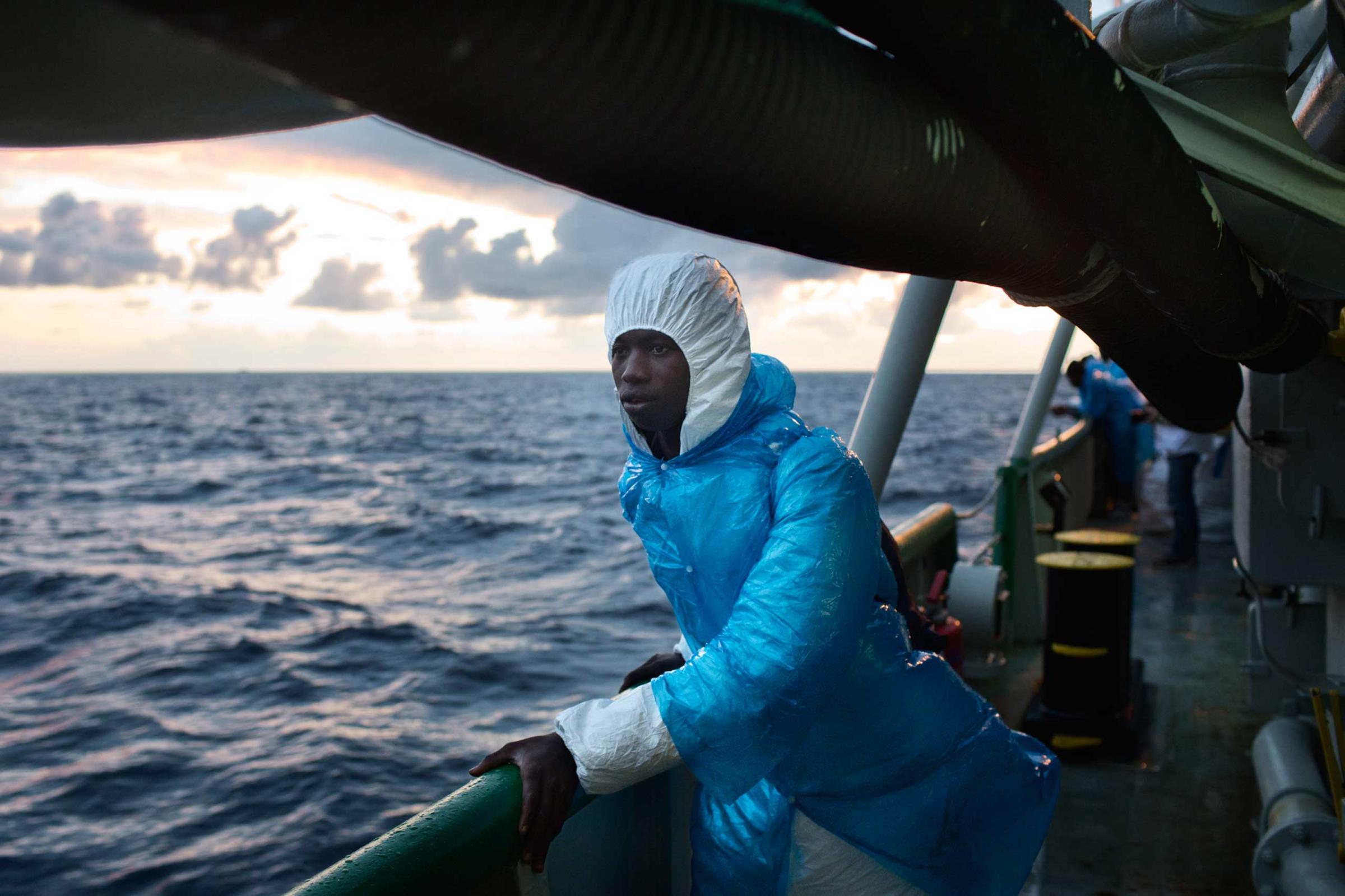 A migrant aboard the Msf ship the Bourbon  Argos, looks toward the Italian island of Lampedusa, where he will be transferred.