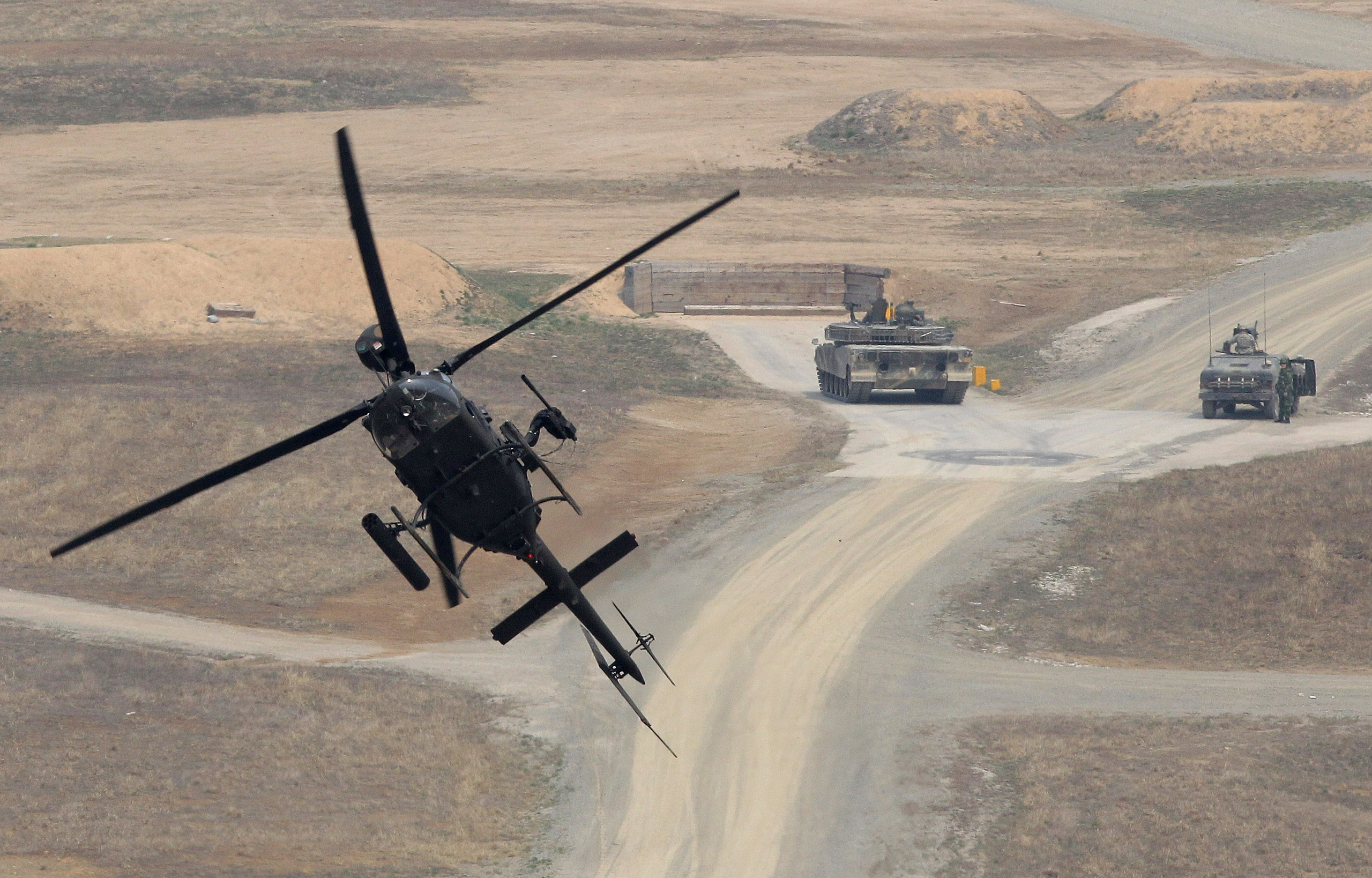 A Kiowa Warrior helicopter hover during the United States and South Korean Joint live fire Exercise at Rodriguez Range in Pocheon, South Korea, on Apr. 11, 2014. (Chung Sung-Jun—Getty Images)