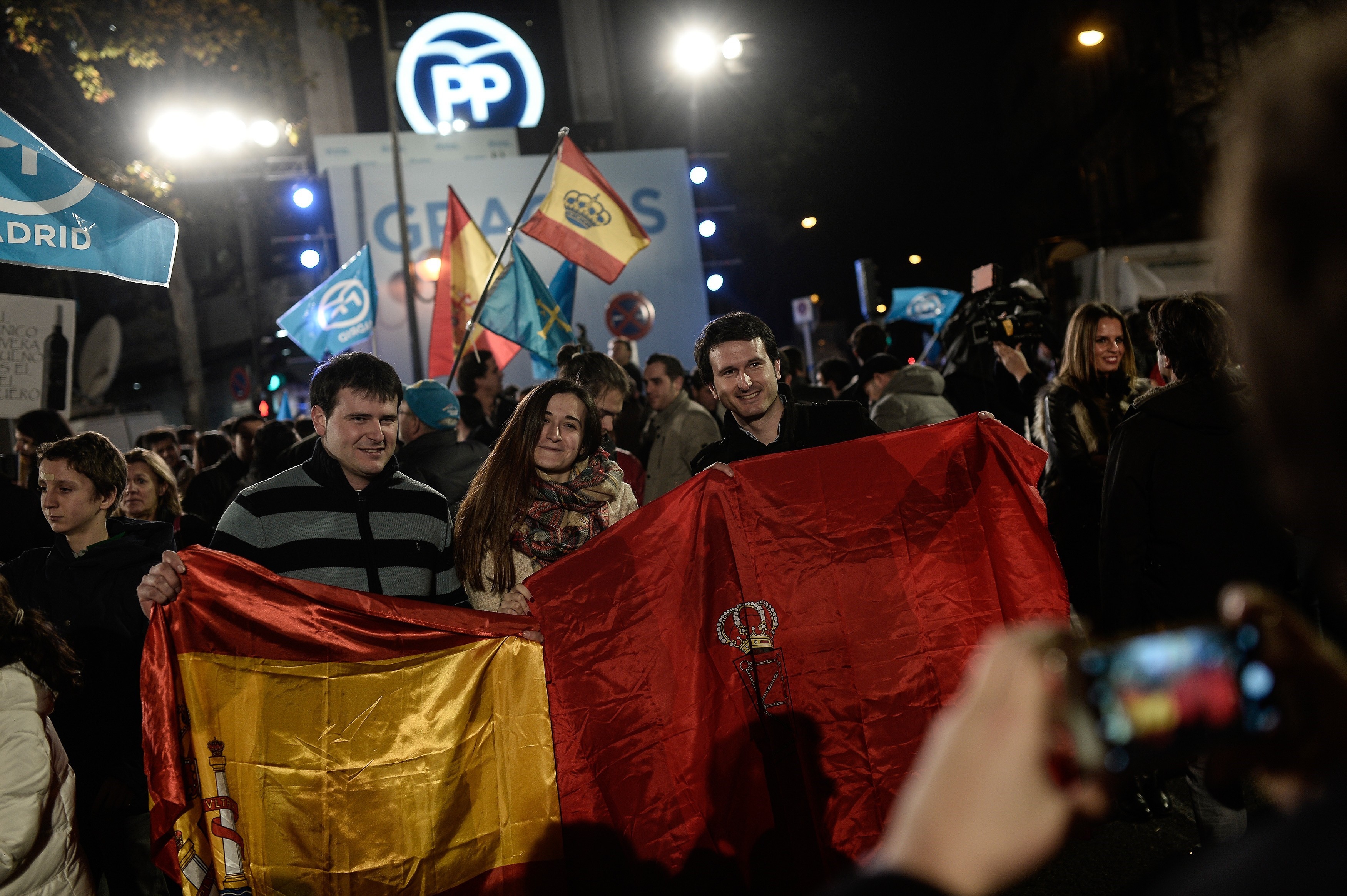 People gather as Spanish Prime Minister and Popular Party (PP) leader, Mariano Rajoy (not seen) gives a speech at his party headquarters'  balcony after Rajoy's party won the most votes of the General Elections during a public meeting with supporters in Madrid, Spain on Dec. 21, 2015. (Burak Akbulut/Anadolu Agency/Getty Images)
