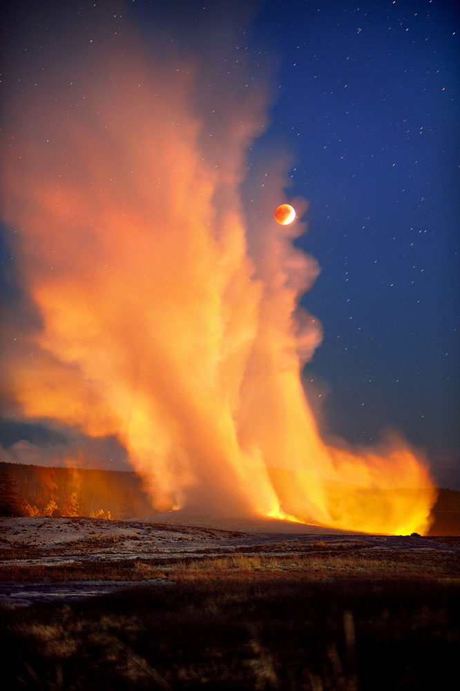 Old Faithful erupts during the super blood moon eclipse on Sept. 27, 2015 over Yellowstone National Park.