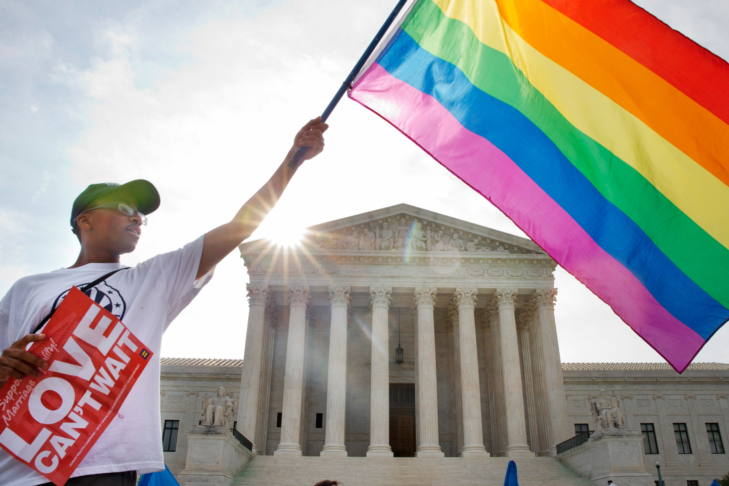 Carlos McKnight waves a flag in support of gay marriage outside of the Supreme Court in Washington on June 26, 2015. (Jacquelyn Martin—AP)