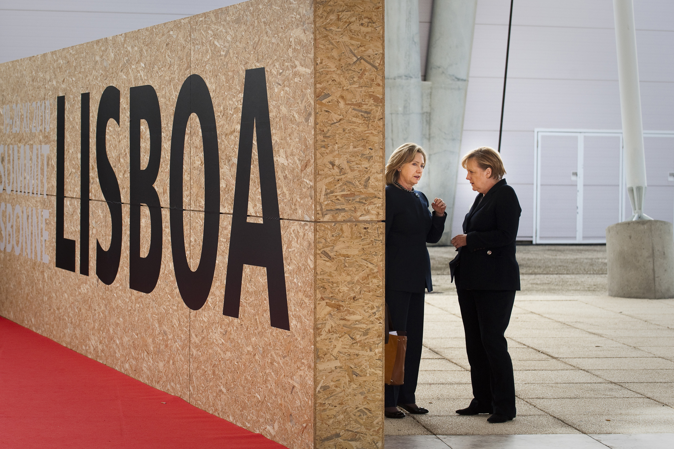 Chancellor Angela Merkel shares a conversation with the then Secretary of State, Hillary Clinton at the NATO Summit in Lisbon. Nov. 20, 2010.