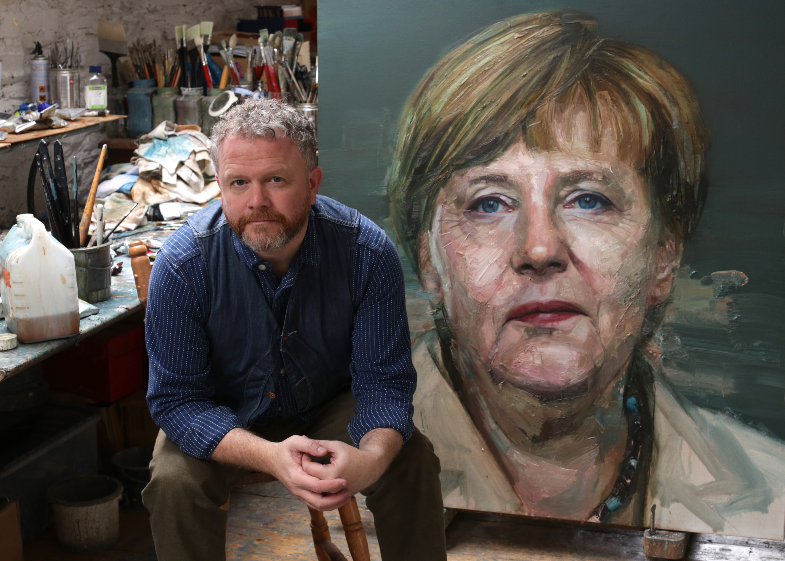 Artist Colin Davidson with his painting of Angela Merkel commissioned for the cover of TIME's  2015 Person of the Year issue (TIME)