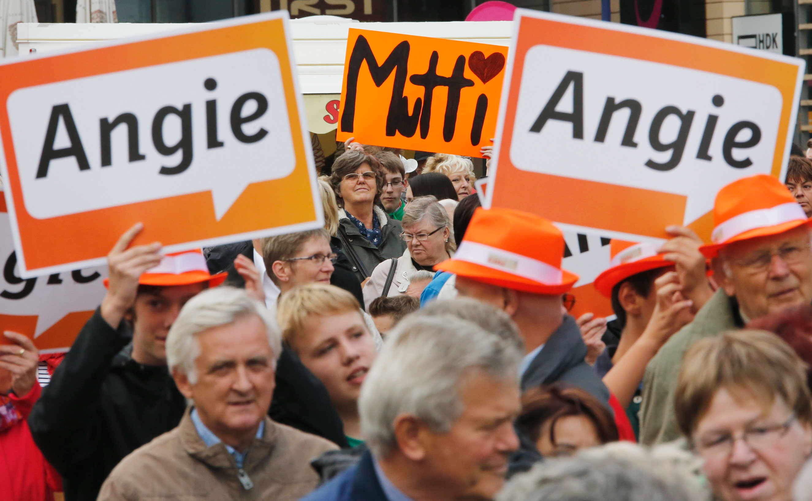 Elderly supporters hold placards that read  Angie  an  Mutti  (Mummy) the nicknames of German Chancellor and conservative Christian Democratic Union (CDU) leader Angela Merkel, at a CDU election campaign rally in Magdeburg on Sept. 17, 2013.