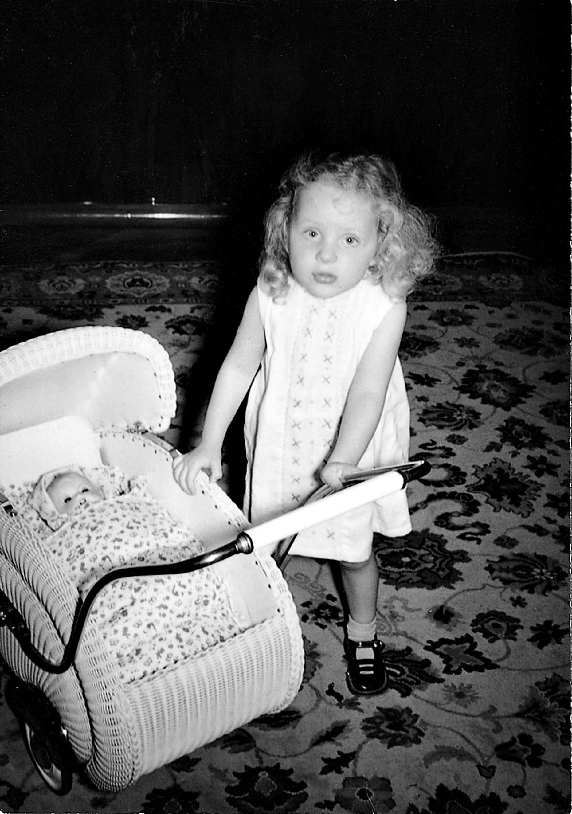 Angela Kasner as a child with a stroller.