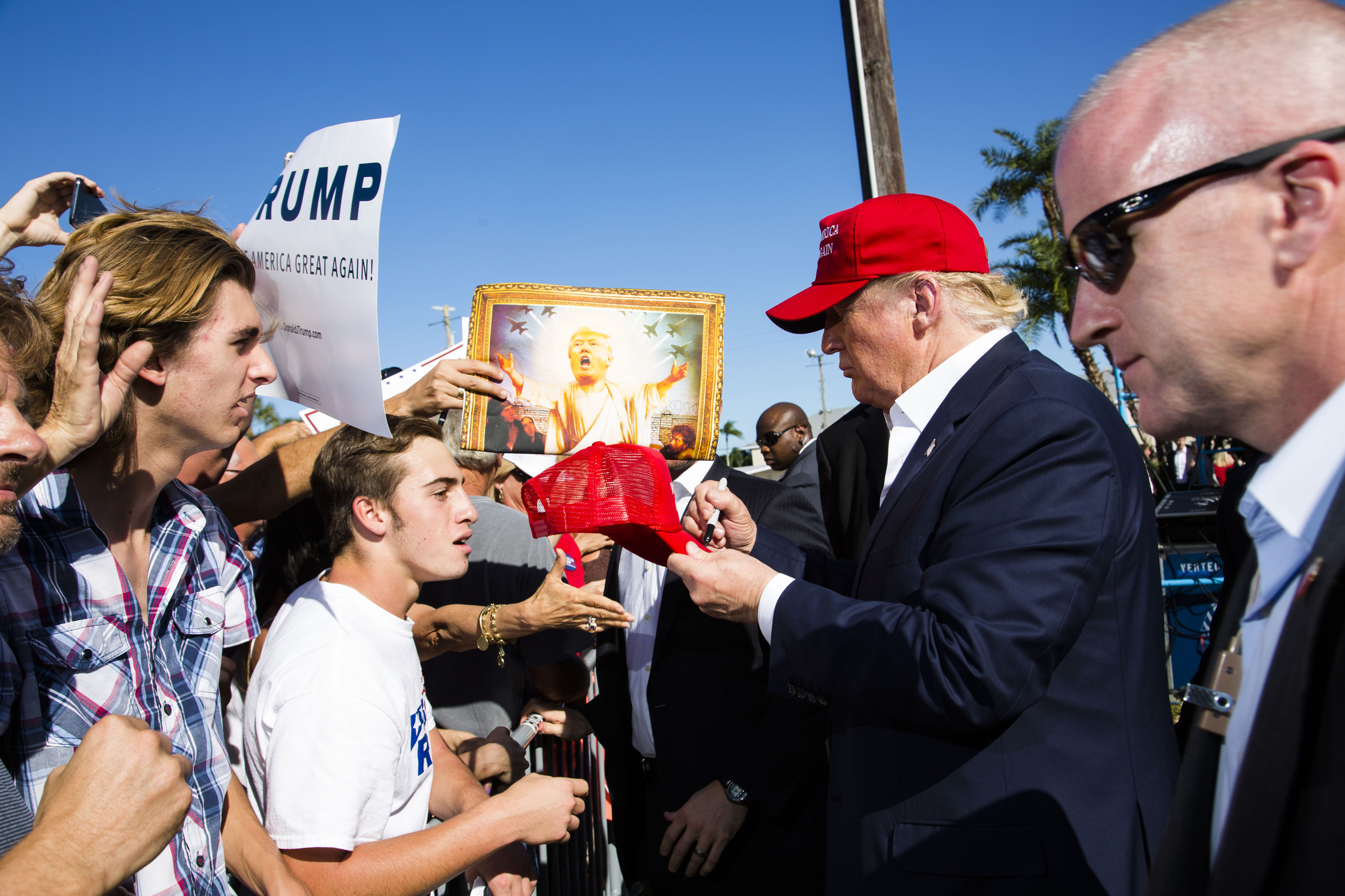 Republican presidential candidate Donald Trump meets with supporters after arriving in his helicopter as a group of children race towards it for ride during a rally in Sarasota, Fla. Nov. 28, 2015.