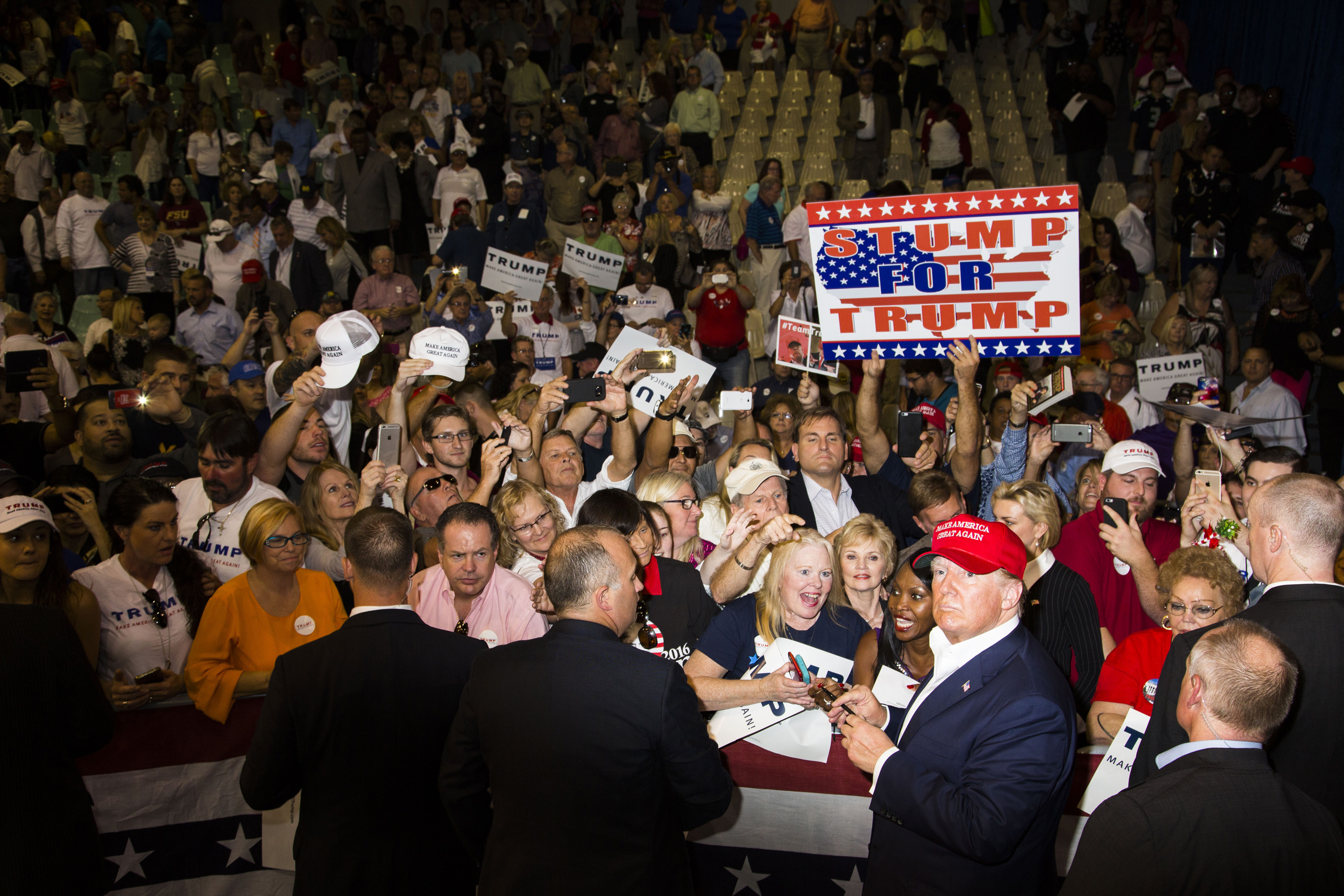 Supporters reacts to getting autographs from Republican presidential candidate Donald Trump following his rally in Sarasota, Fla. Nov. 28, 2015.
