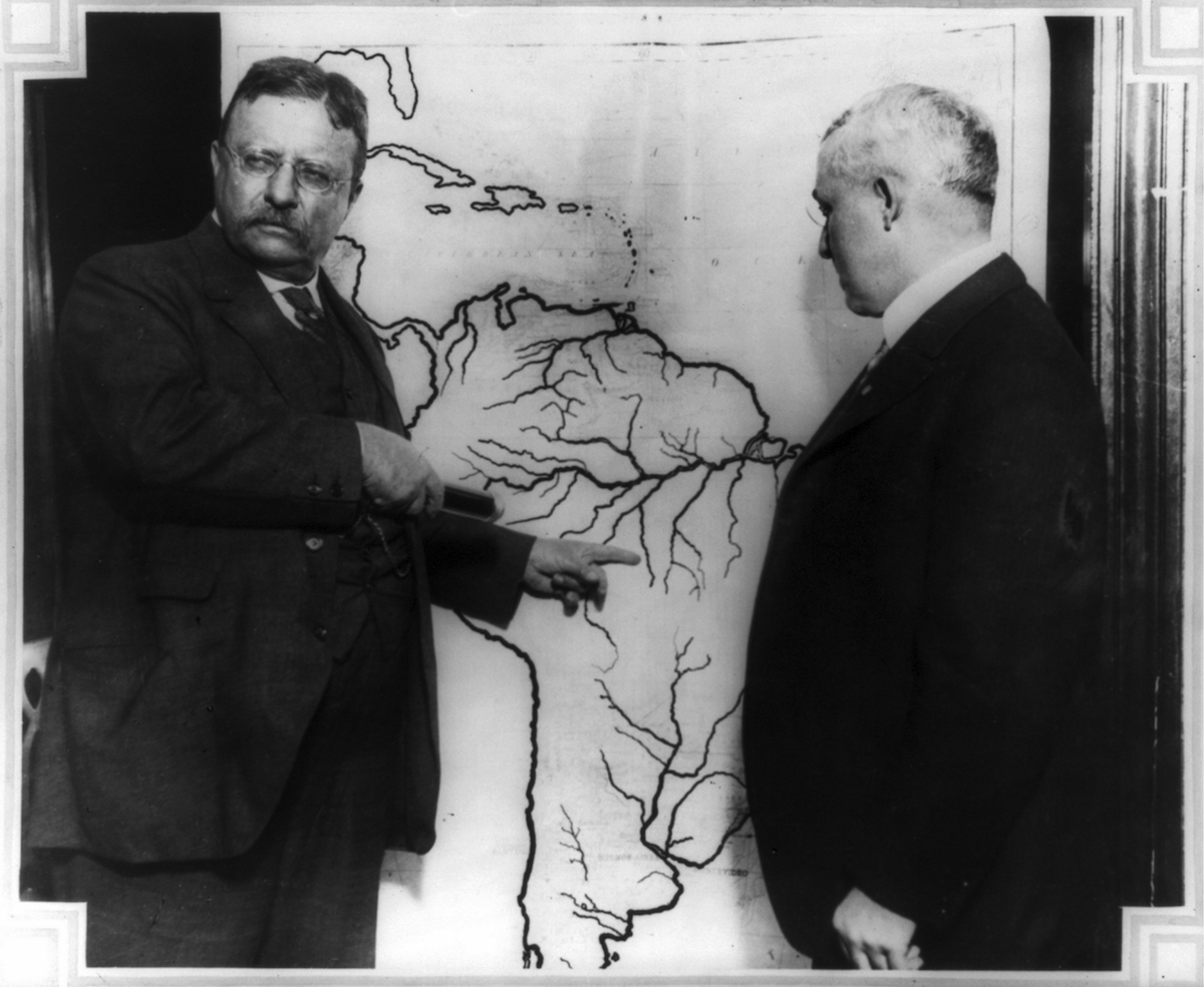 President Roosevelt pointing at a map of South America.