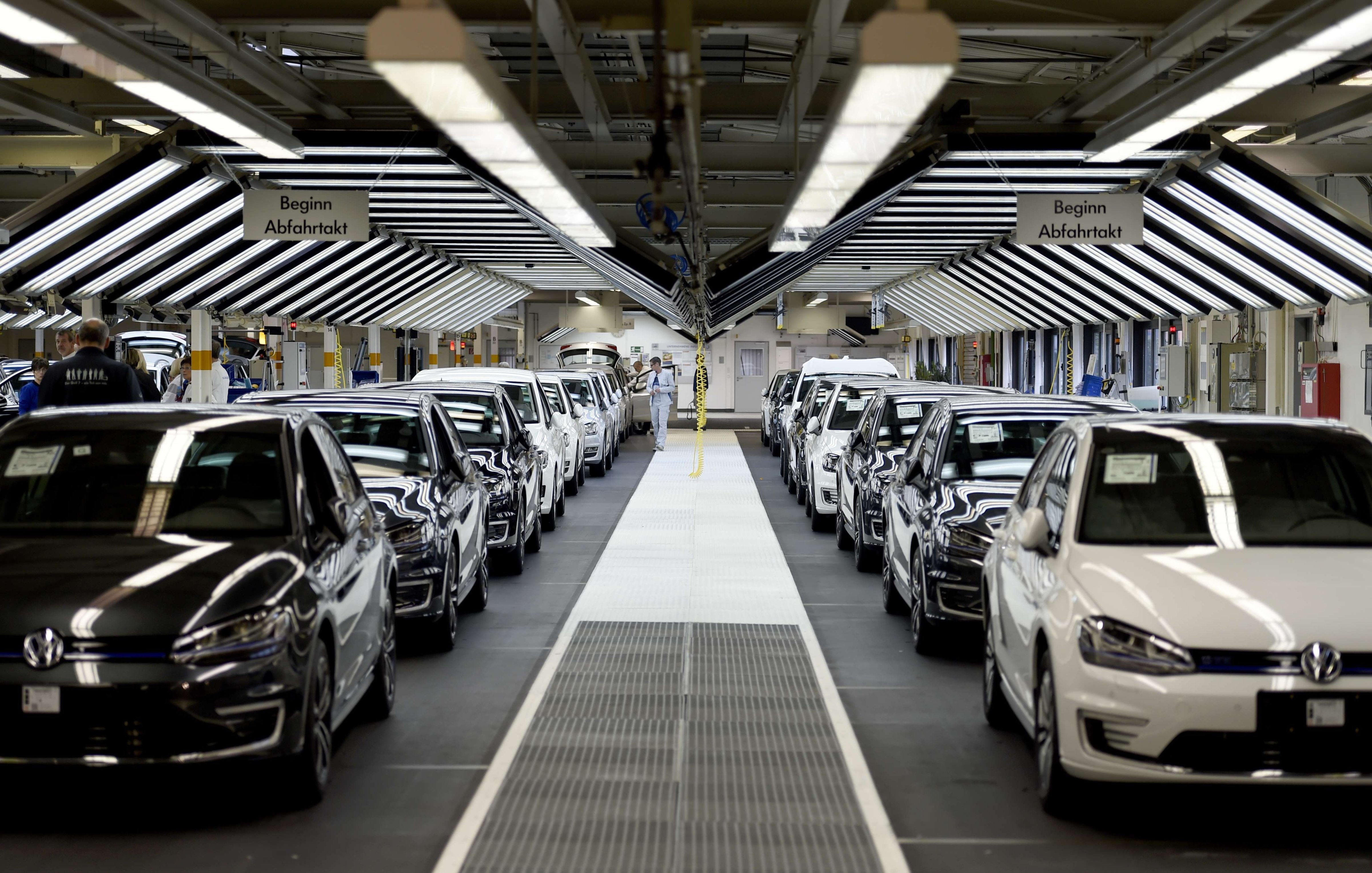 Employees of German car maker Volkswagen check cars at a assembly line of the VW plant in Wolfsburg, Germany, Oct. 21, 2015. (Odd Andersen—AFP/Getty Images)