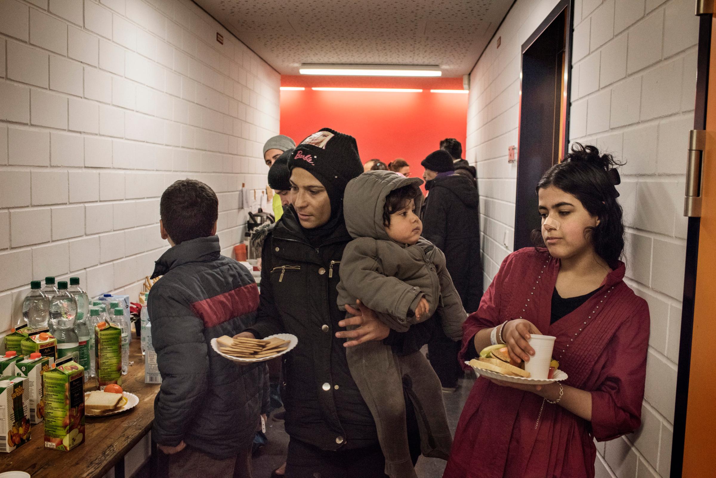 Refugees stay at the emergency shelter in a sports hall, in the districts of Prenzlauer Berg, Berlin, Germany, Dec. 2015.