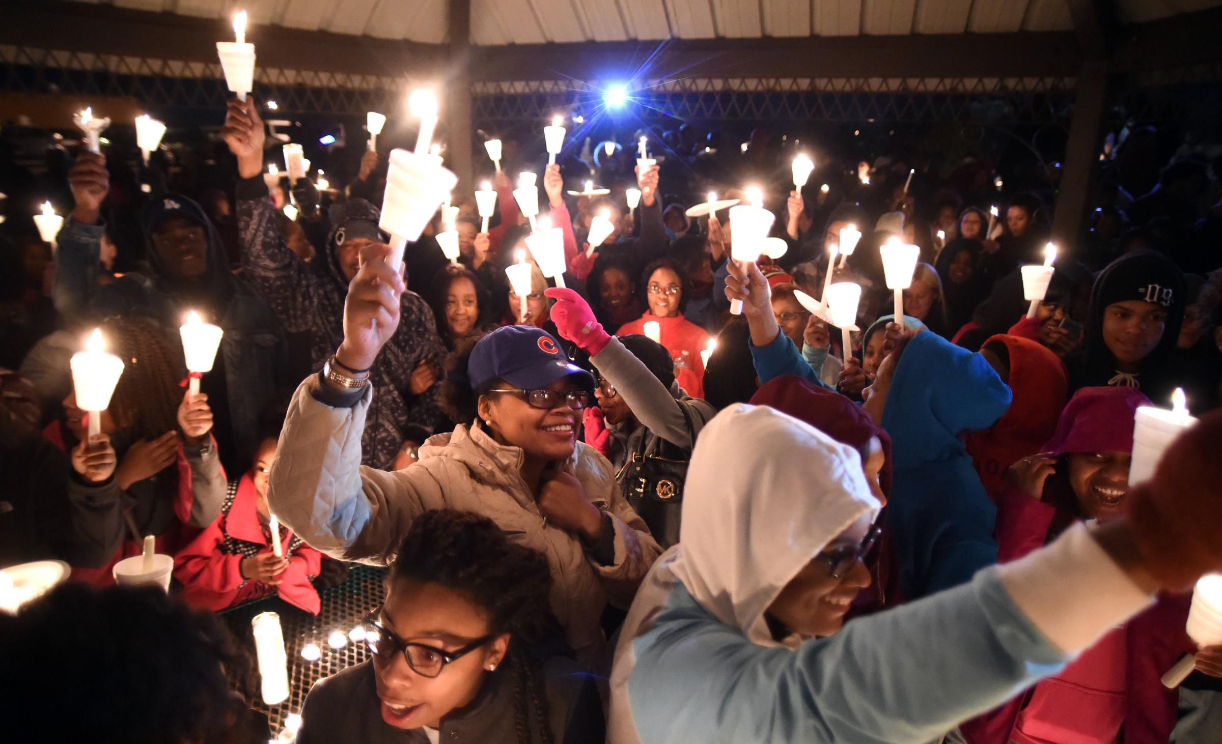 Attendees raise candles to celebrate the life of Zaevion Dobson at Sam E. Hill Park in Knoxville, Tenn., on Dec. 18, 2015.