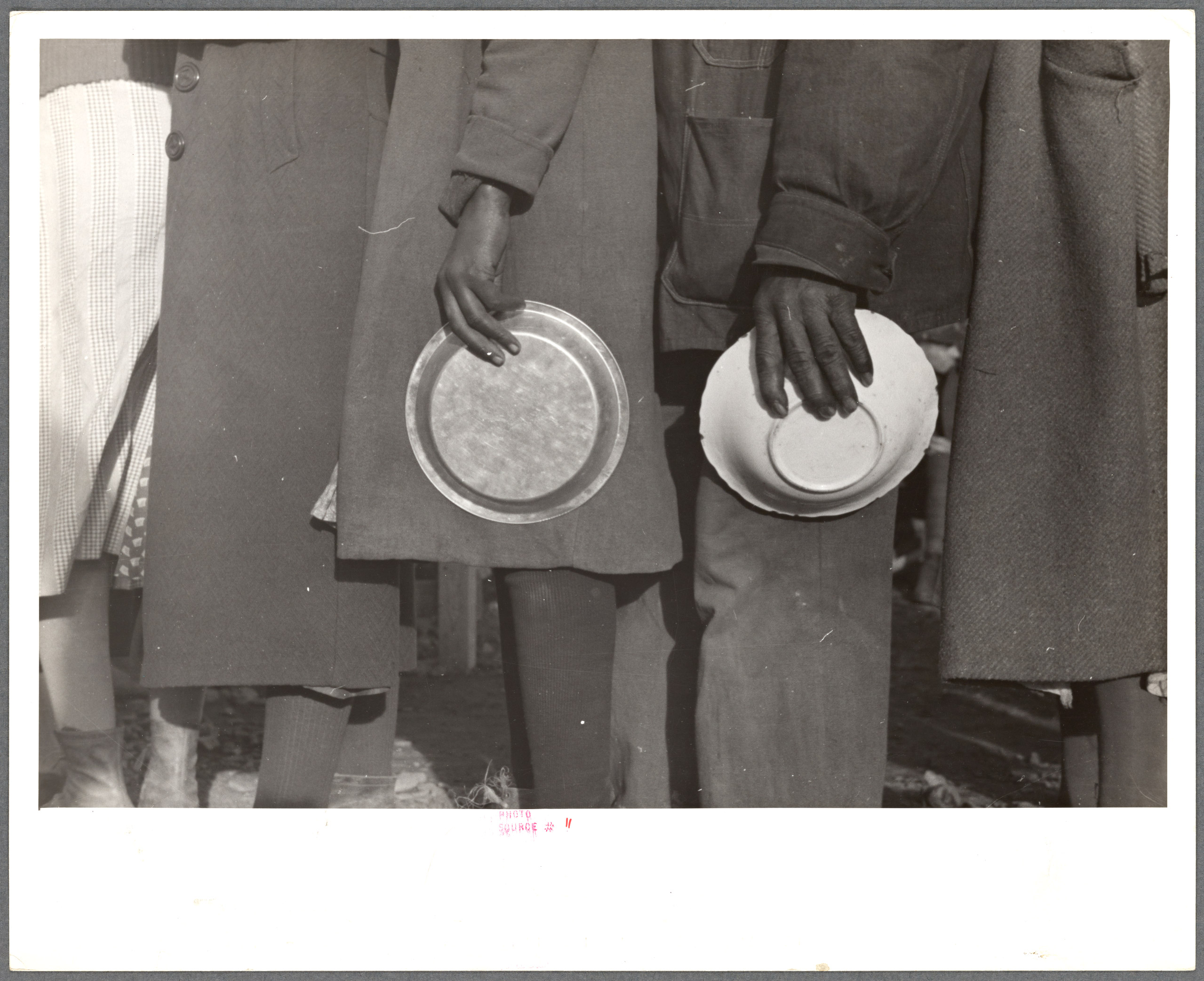 Negroes in the lineup for food at mealtime in the camp for flood refugees, Forrest City, Arkansas,  1937. Photographed for the Farm Security Administration.