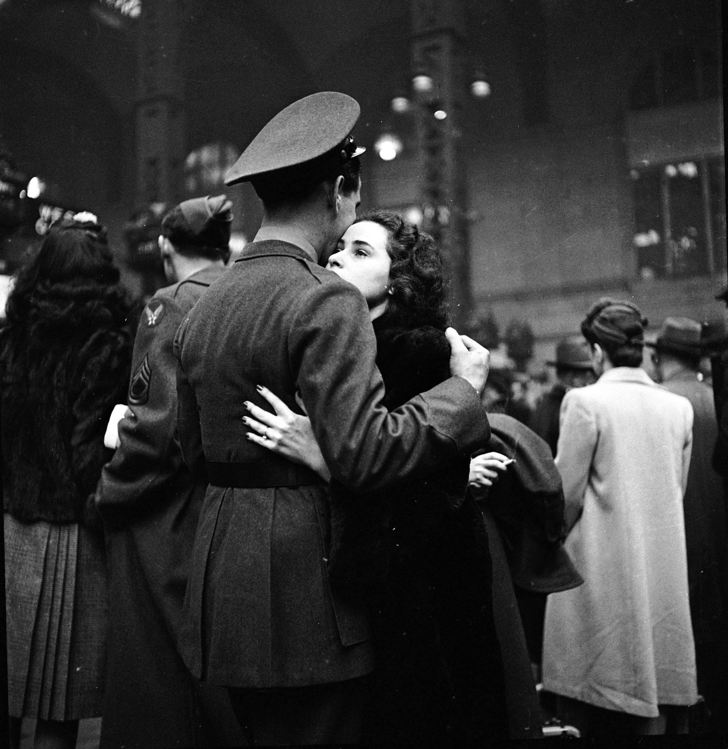 Soldier hugging his wife goodbye at Penn Station before he leaves for war, 1944.