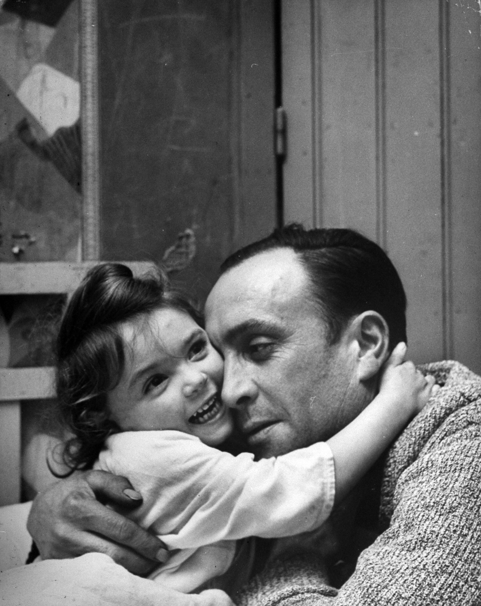 A man hugging his daughter, 1949.