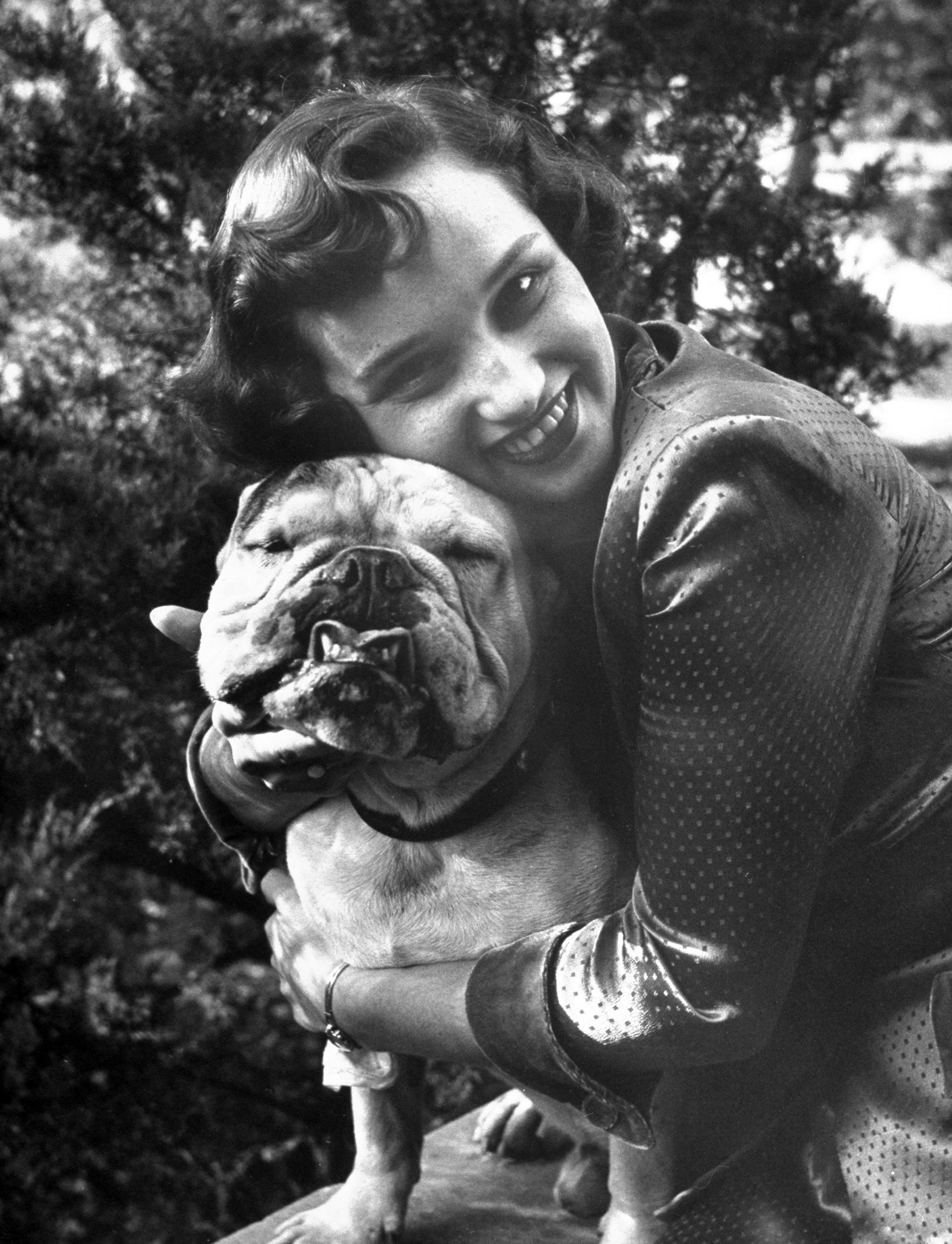 A woman hugs her dog, Bruiser, 1950.