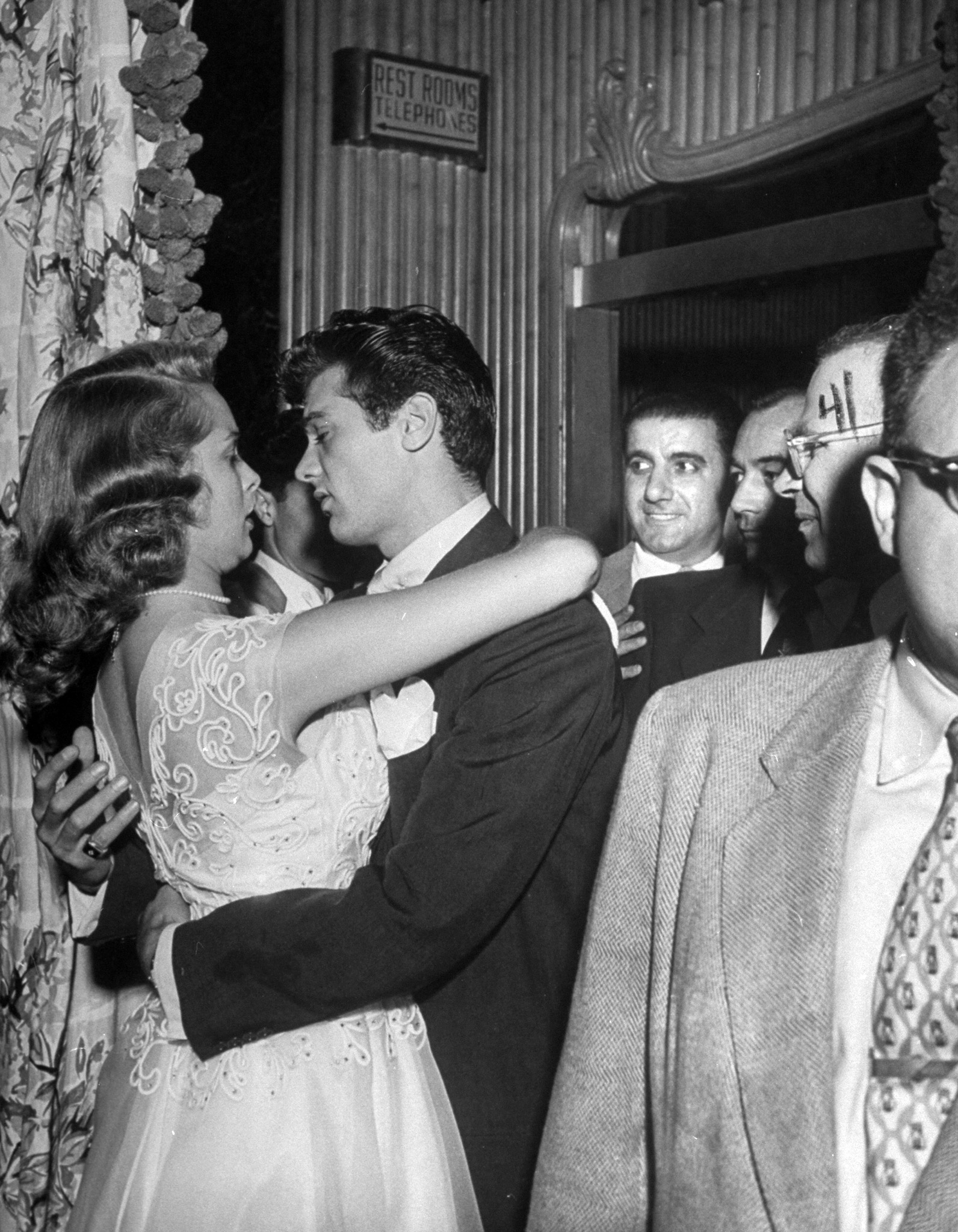 Janet Leigh and Tony Curtis embracing at party celebrating their marriage, 1951.