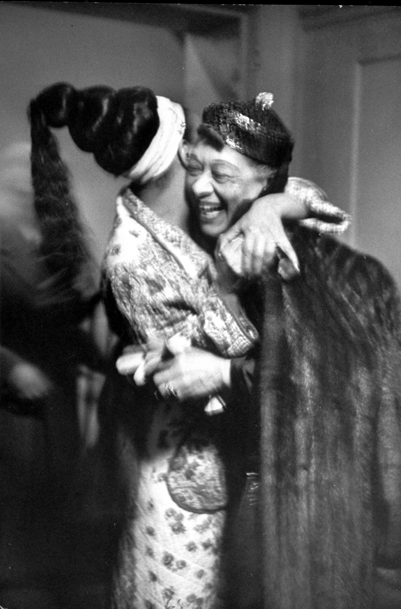 Josephine Baker receiving hug from columnist and friend Nora Ray Holt in her dressing room after her show at the Strand theater, 1951.