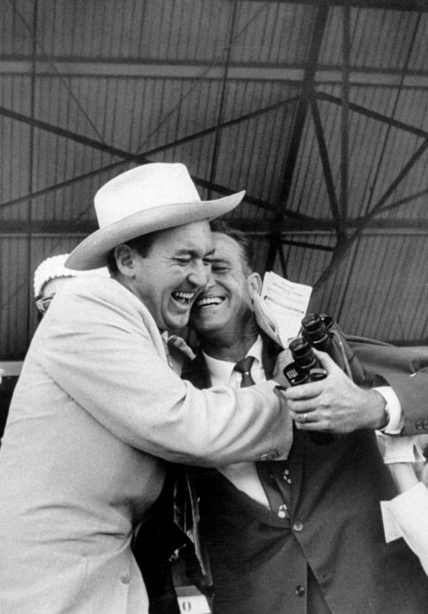 Owner of race horse "Needles", Bonnie Heath and co-owner, Jackson C. Dudley, Hug as "Needles" flashes across the finish line the winner, at the Kentucky Derby, 1956.