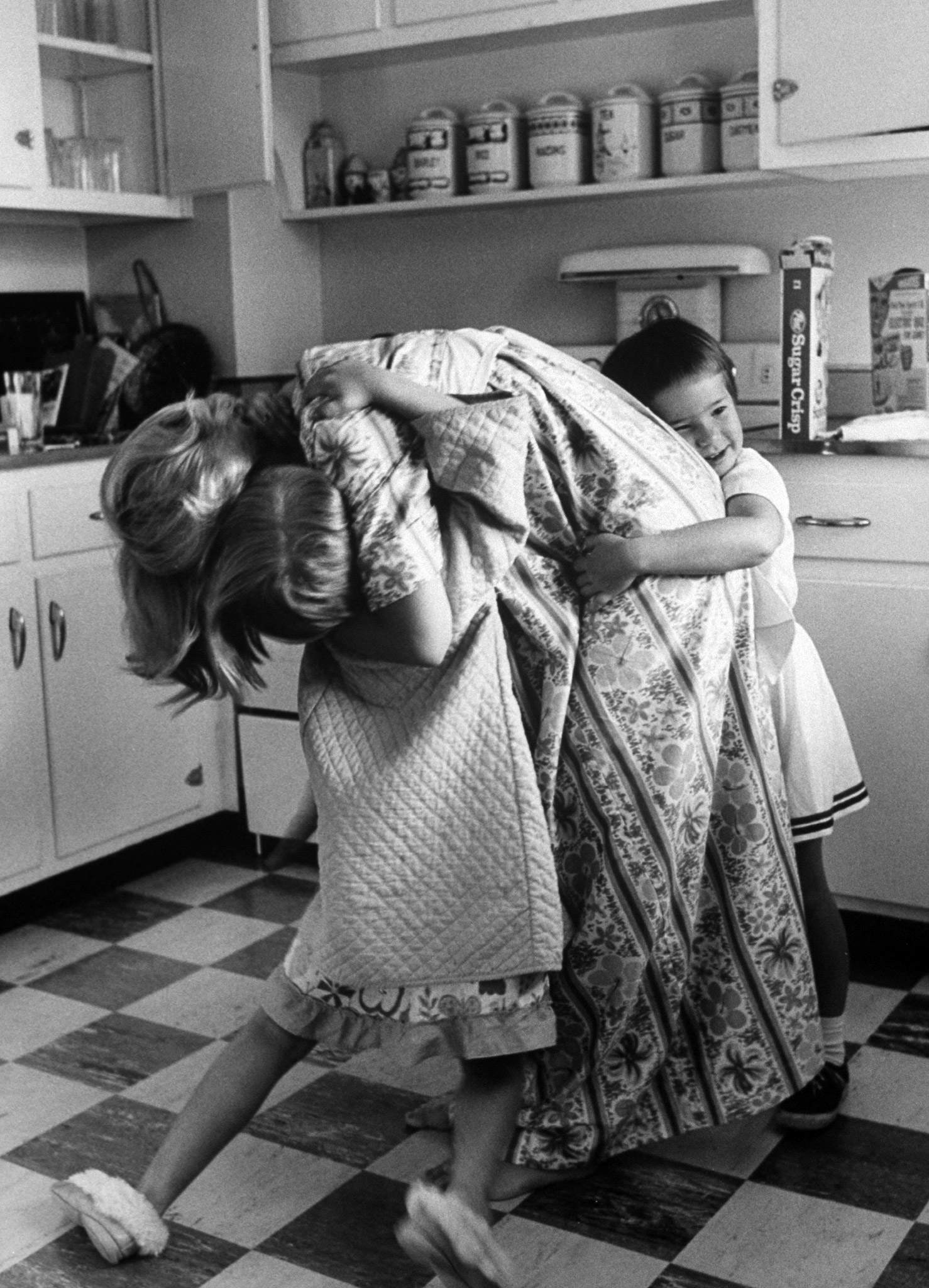 Mrs. Malcolm S. Carpenter hugging her children, 1962.