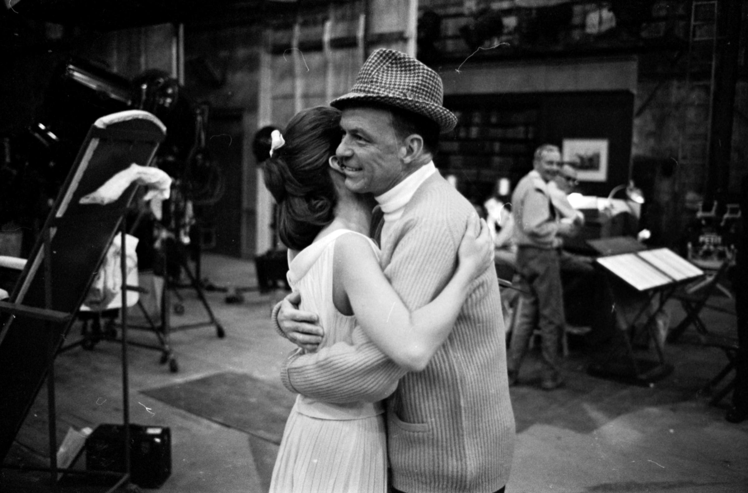 Frank Sinatra shares a hug at his Warner Bros Studio, 1965.