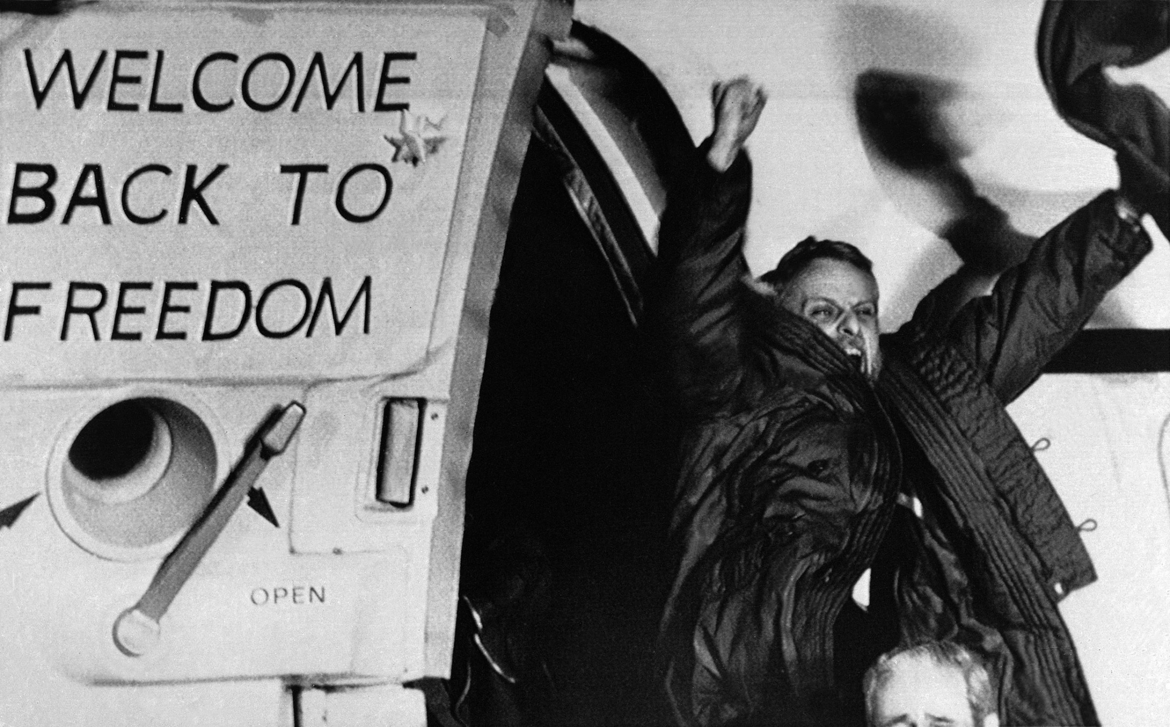 Freed U.S. hostage David Roeder shouts and waves as he arrives at Rhein-Main U.S. Air Force base in Frankfurt, Germany. Roeder was among 52 Americans held hostage in Iran for 444 days after their capture at the U.S. Embassy in Tehran. January 21, 1981.