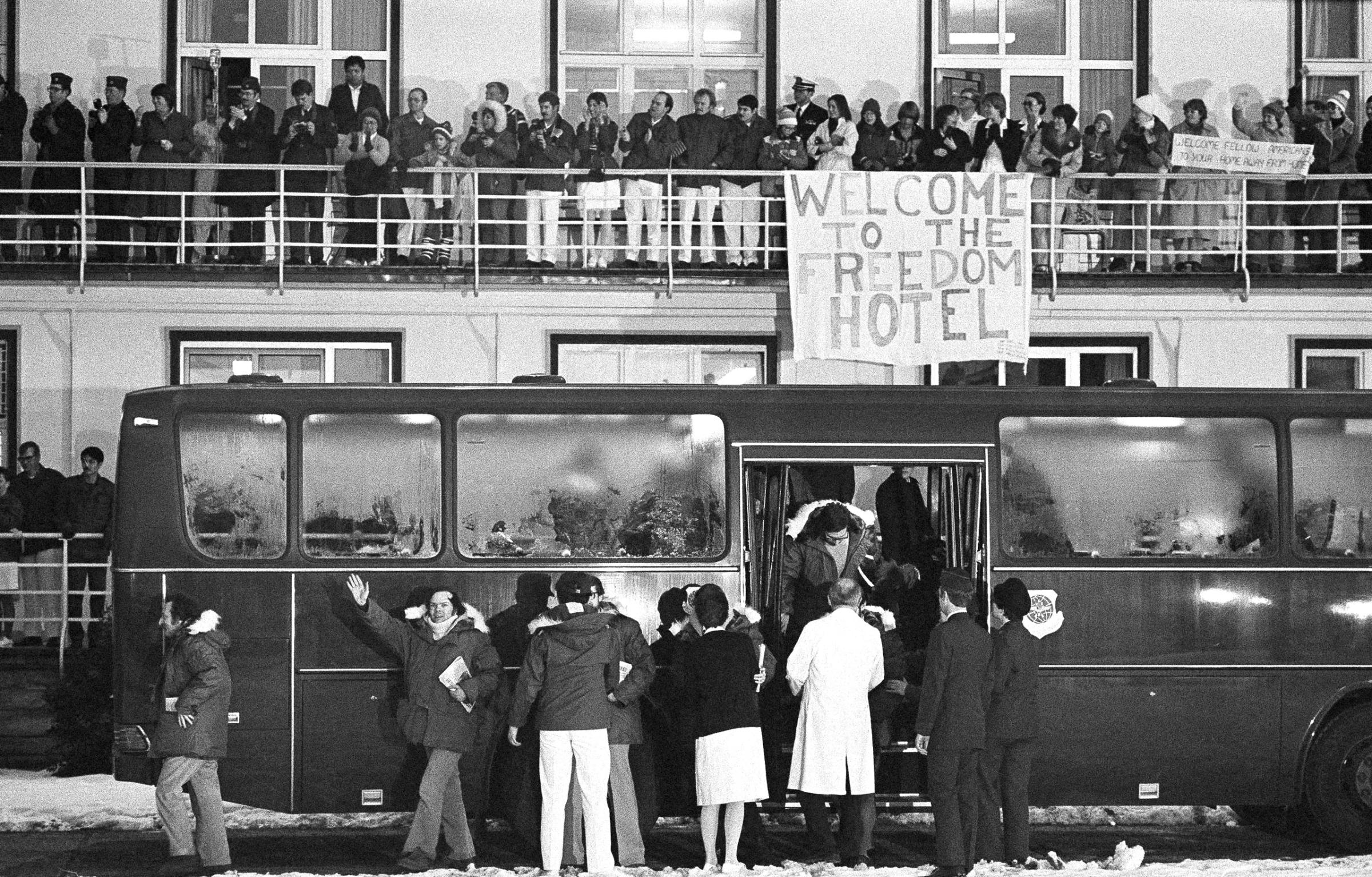 A crowd of well-wishers on the balconies of the Wiesbaden U.S. Air Force hospital greets the 52 Americans released by the Iranian government, January 21, 1981, after being held hostage for 444 days. A sign displayed by a group of people reads, "Welcome to the Freedom Hotel."