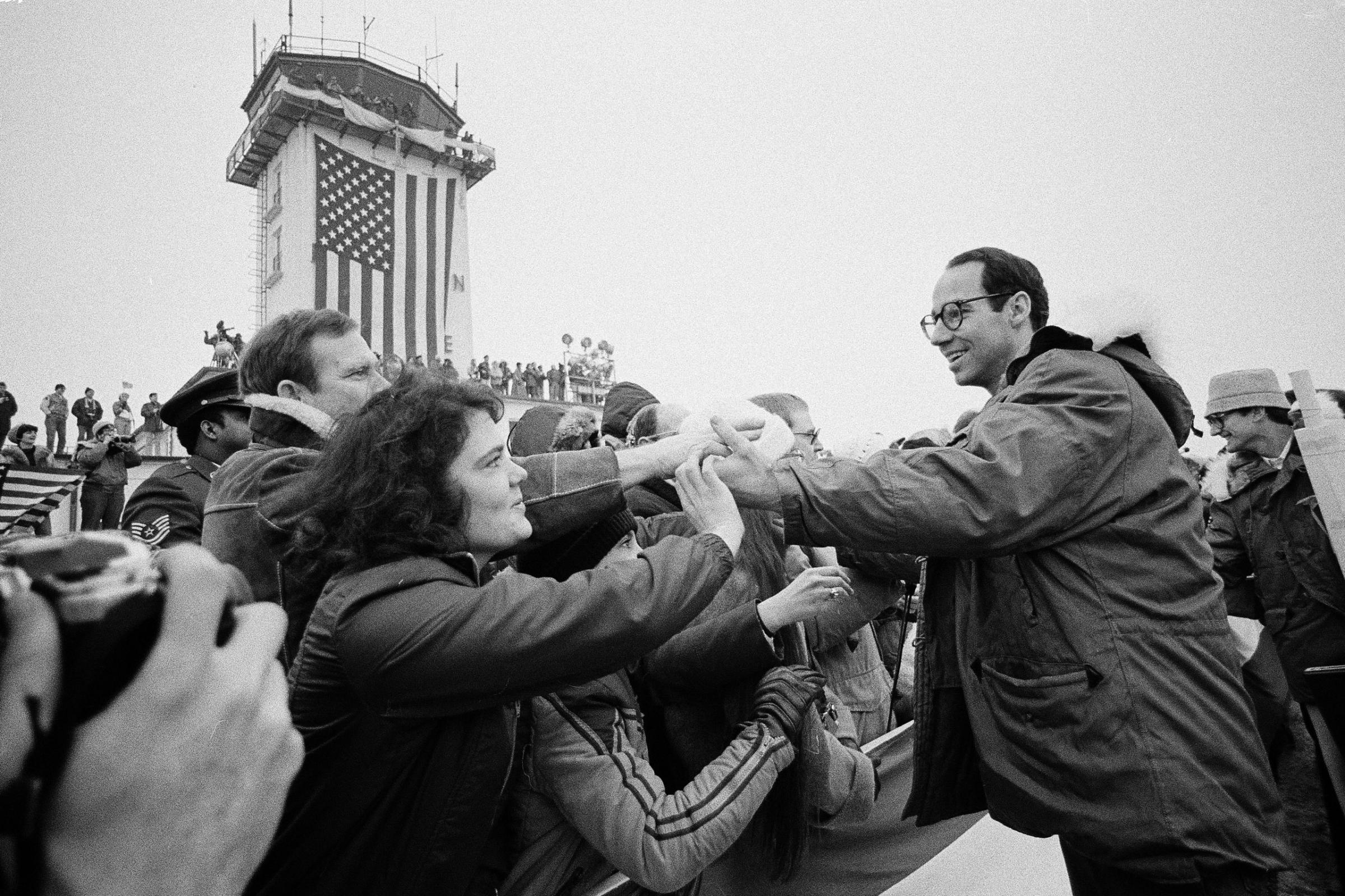 Former American hostage John Graves from Reston, Va., shakes hands with people in the crowd at the Rhein-Main U.S. Air Force base in Frankfurt, West Germany on January 21, 1981, shortly before traveling home to the United States.