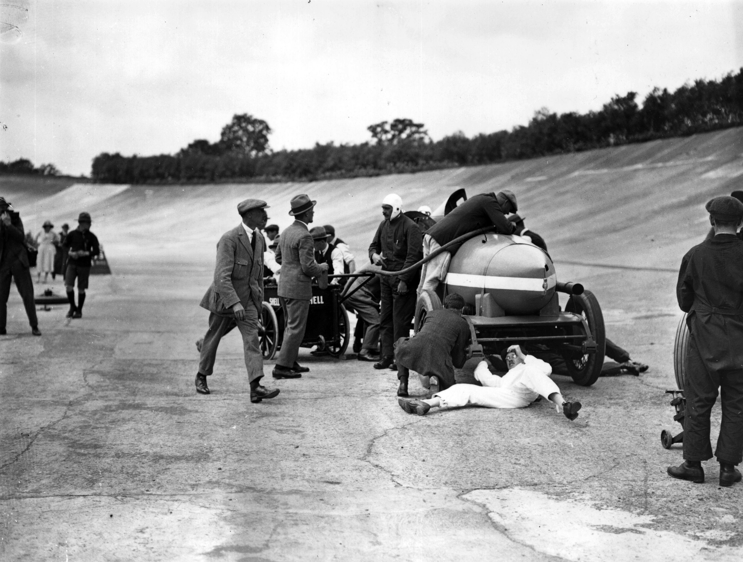 Filling up a Spyker car during a record breaking run by Selwyn F Edge on the Brooklands circuit. Edge averaged 74.27 mph in his Maybach engined Spyker to beat  his own previous 24 hour record set up in 1907. July 1922.