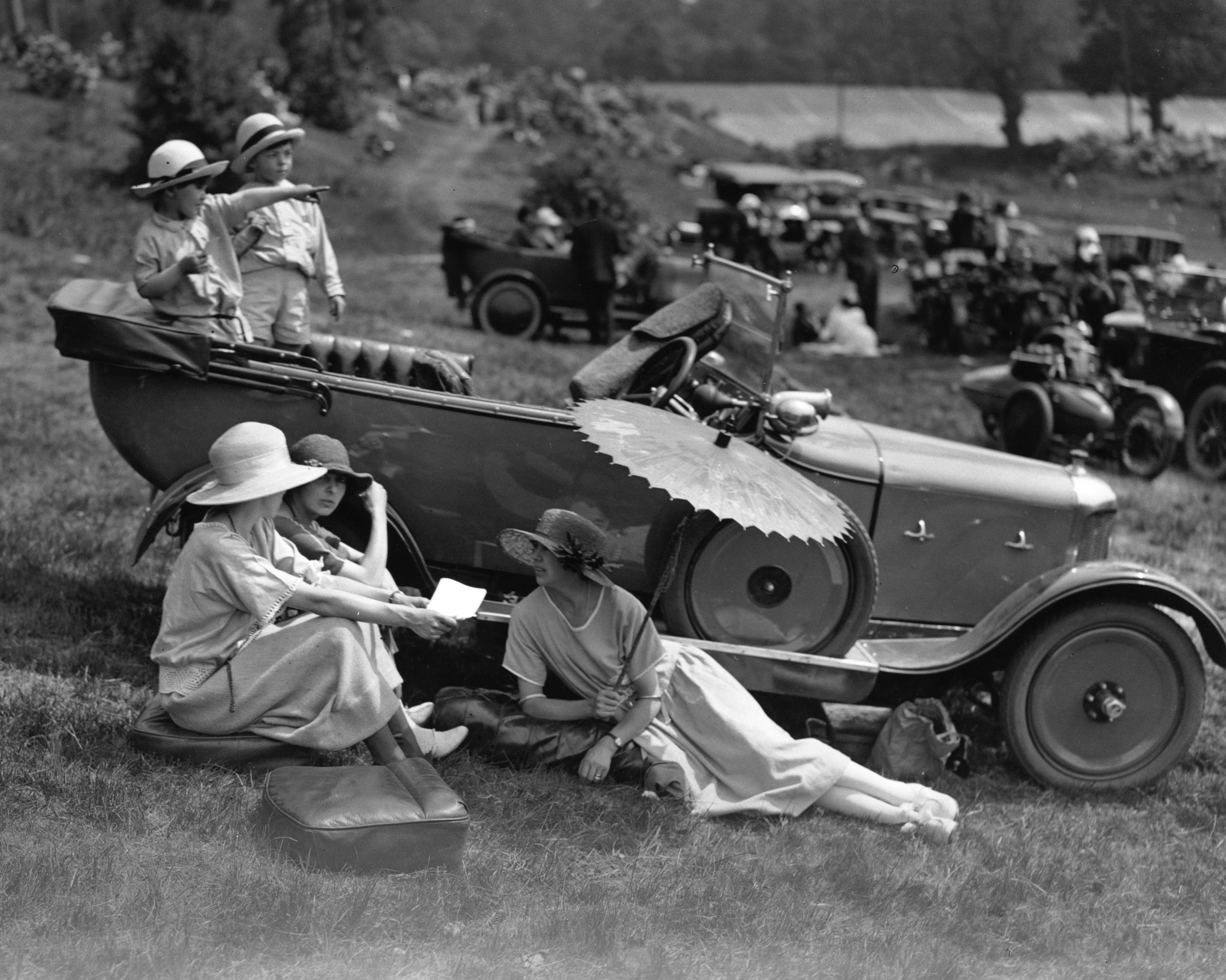 Spectators at Brooklands motor-racing track, Surrey, relaxing in the sunshine.  June 1922.