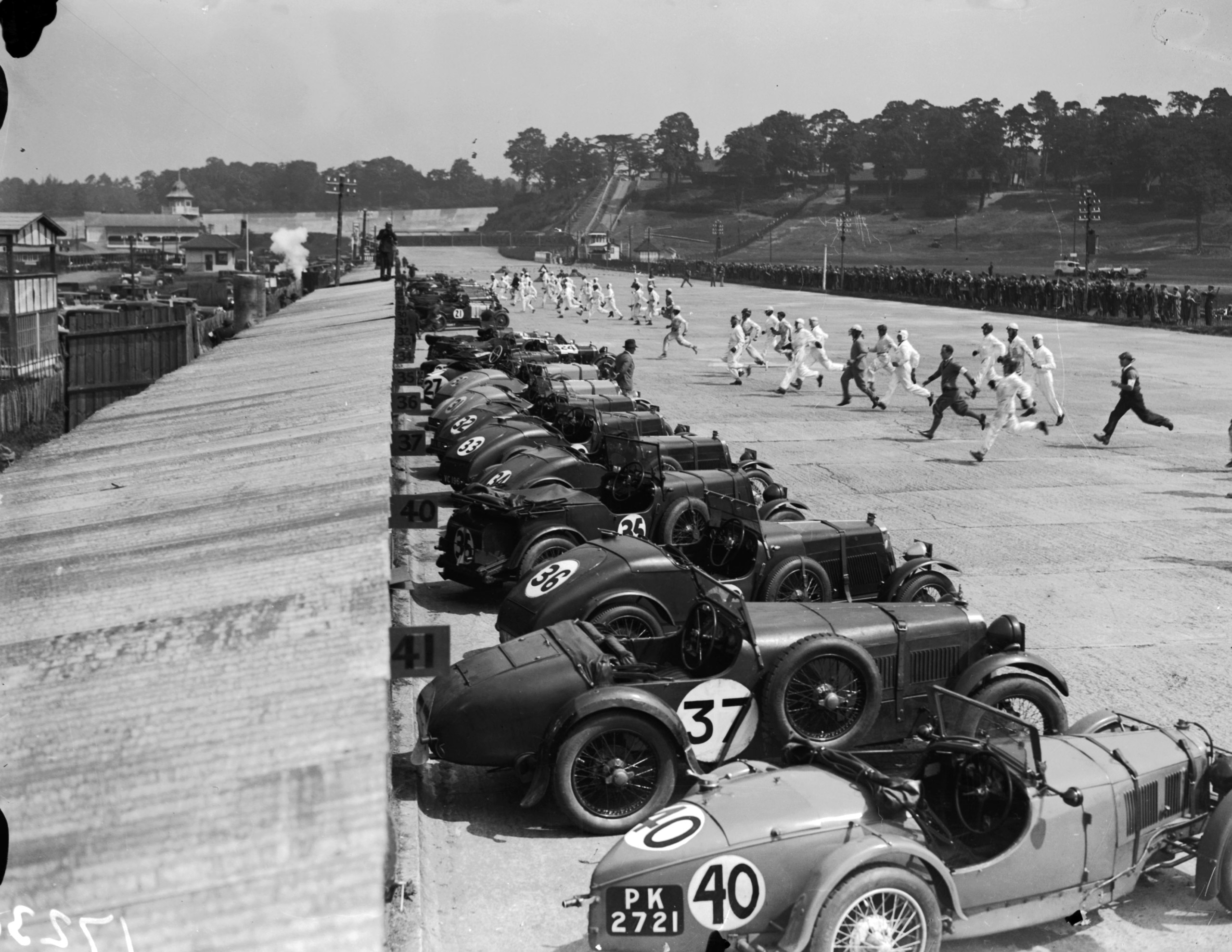 Racing drivers run to their cars as a race begins at Brooklands.  June 1939.