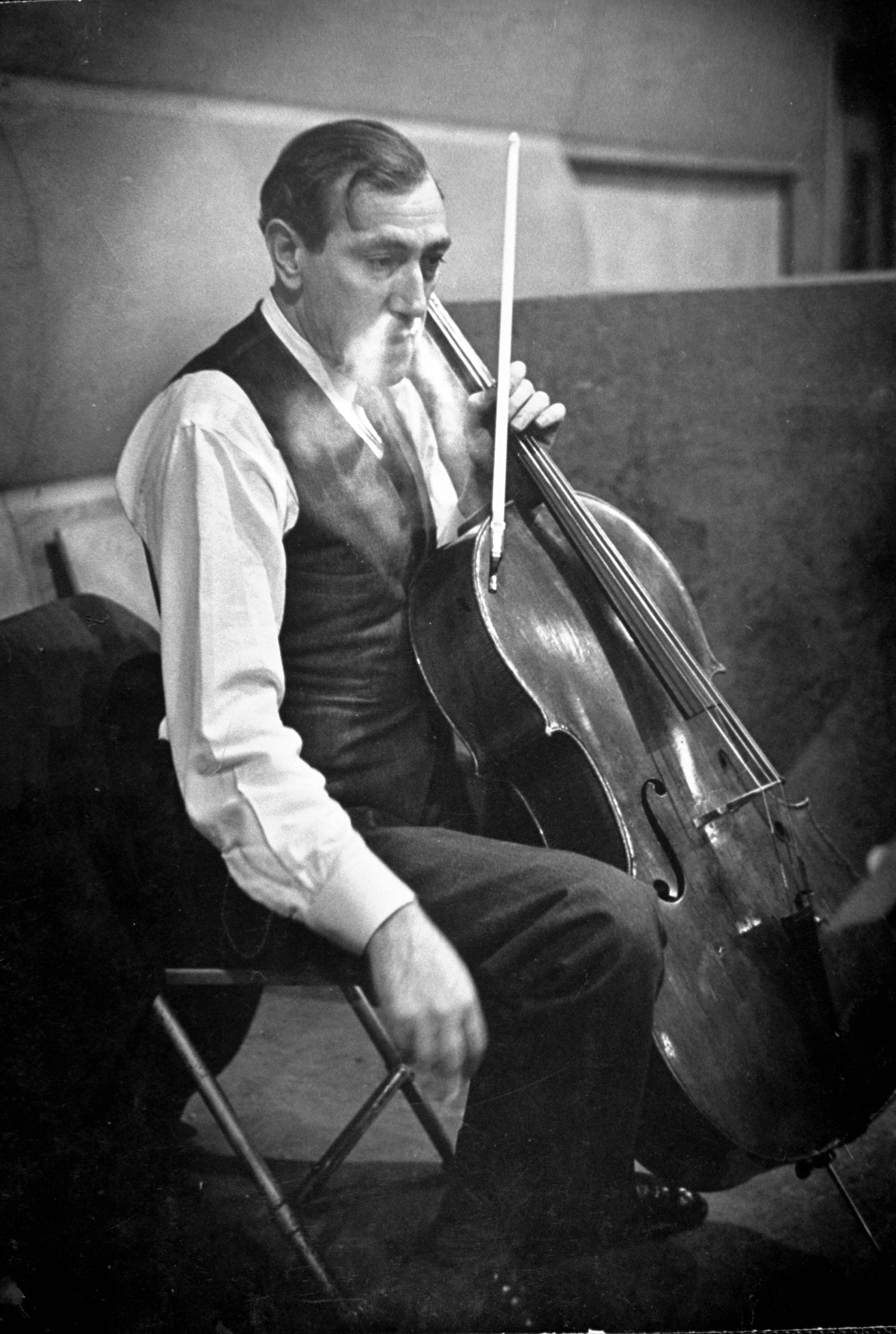 Gregor Piatigorsky unhappily listens to a movement being played back.