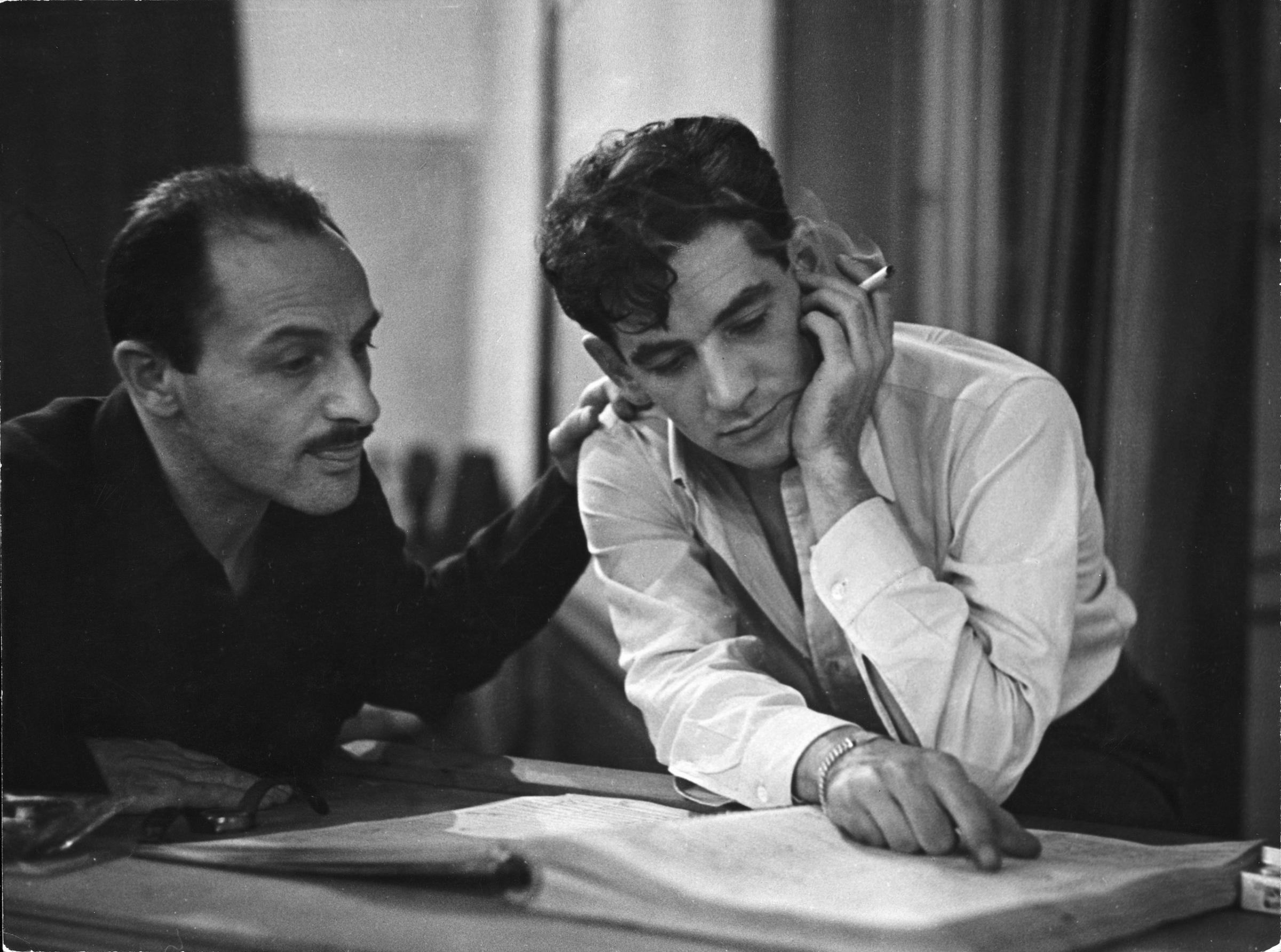 Composer Marc Blitzstein with conductor/composer Leonard Bernstein studying score of a Blitzstein work during a recording session.