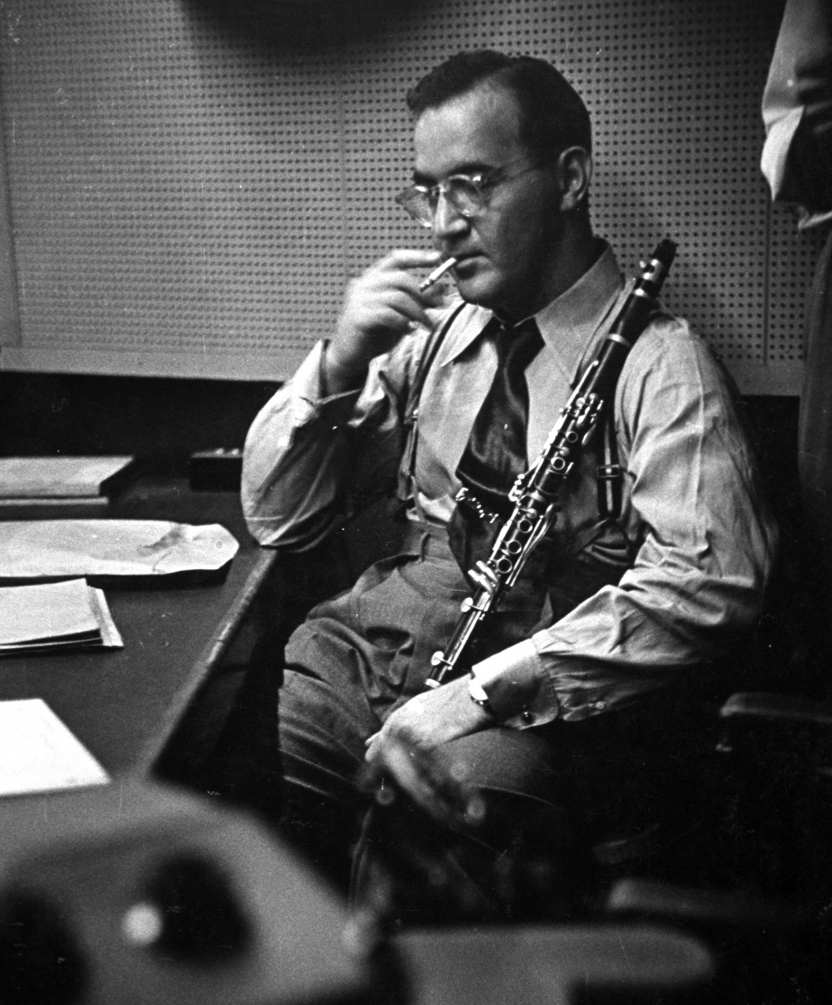 Clarinetist Benny Goodman smokes a cigarette while listening in a CBS recording session.