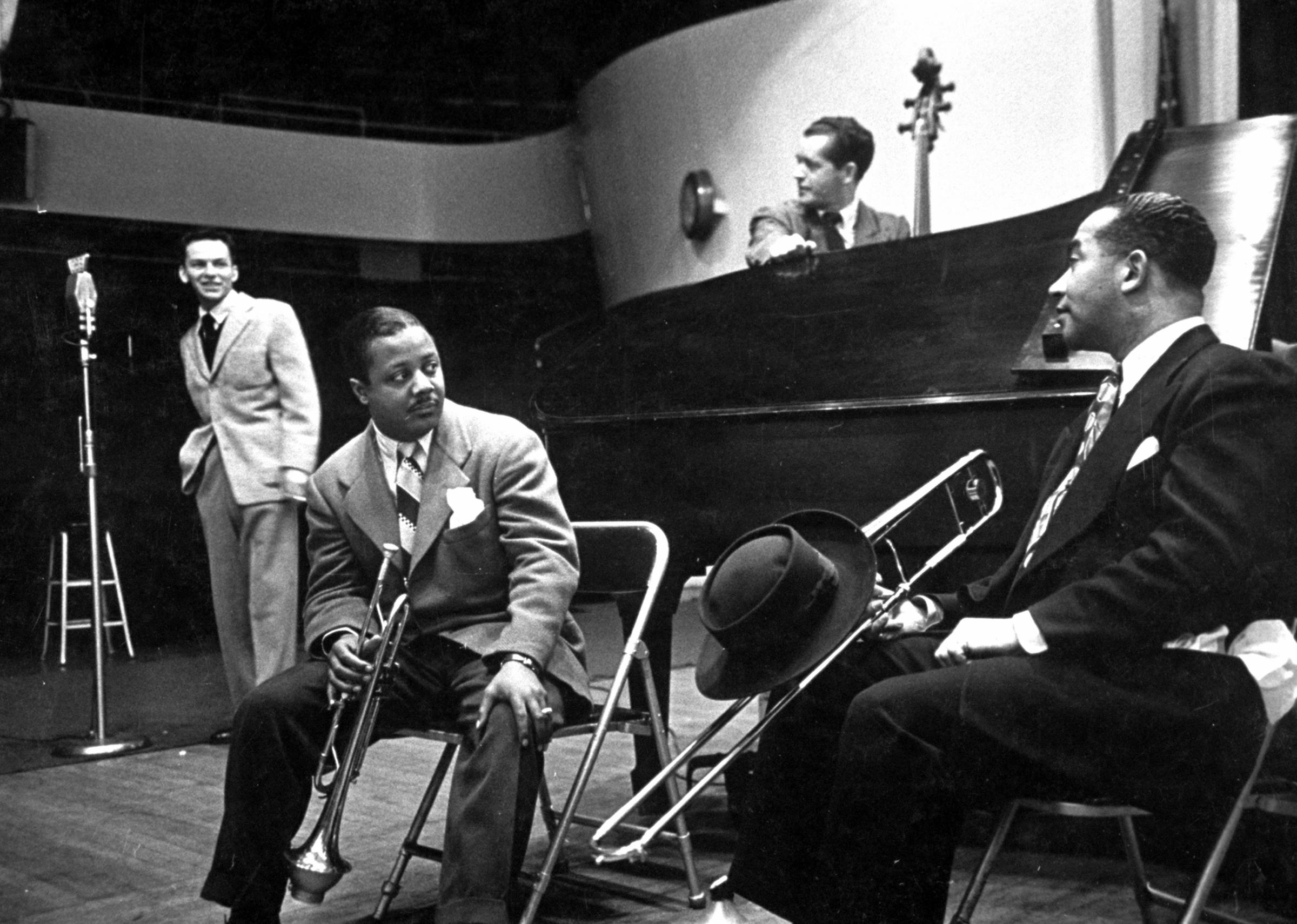 Frank Sinatra and musicians in studio during recording session at CBS.