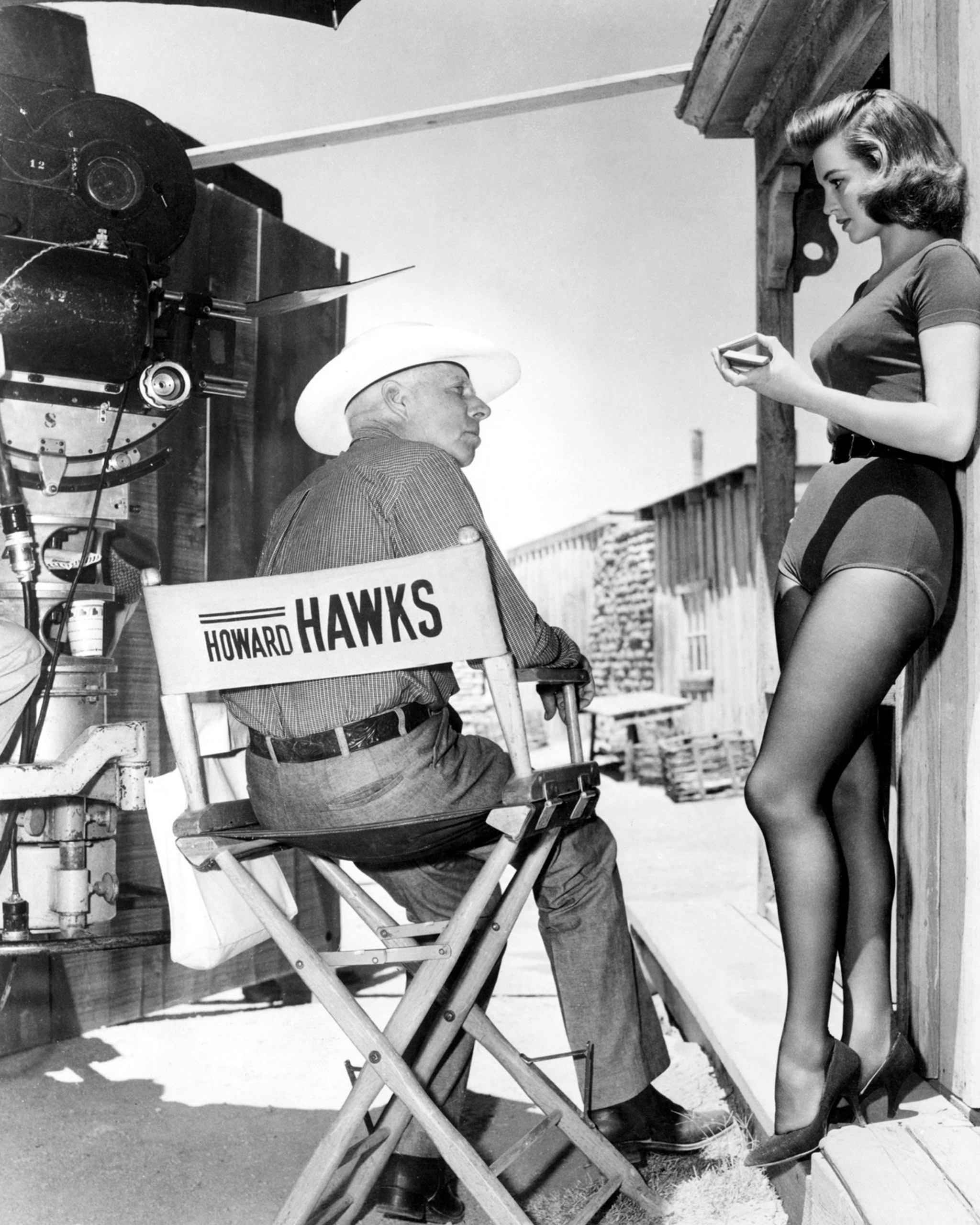 Director Howard Hawks with Angie Dickinson on the set of 'Rio Bravo', 1959.