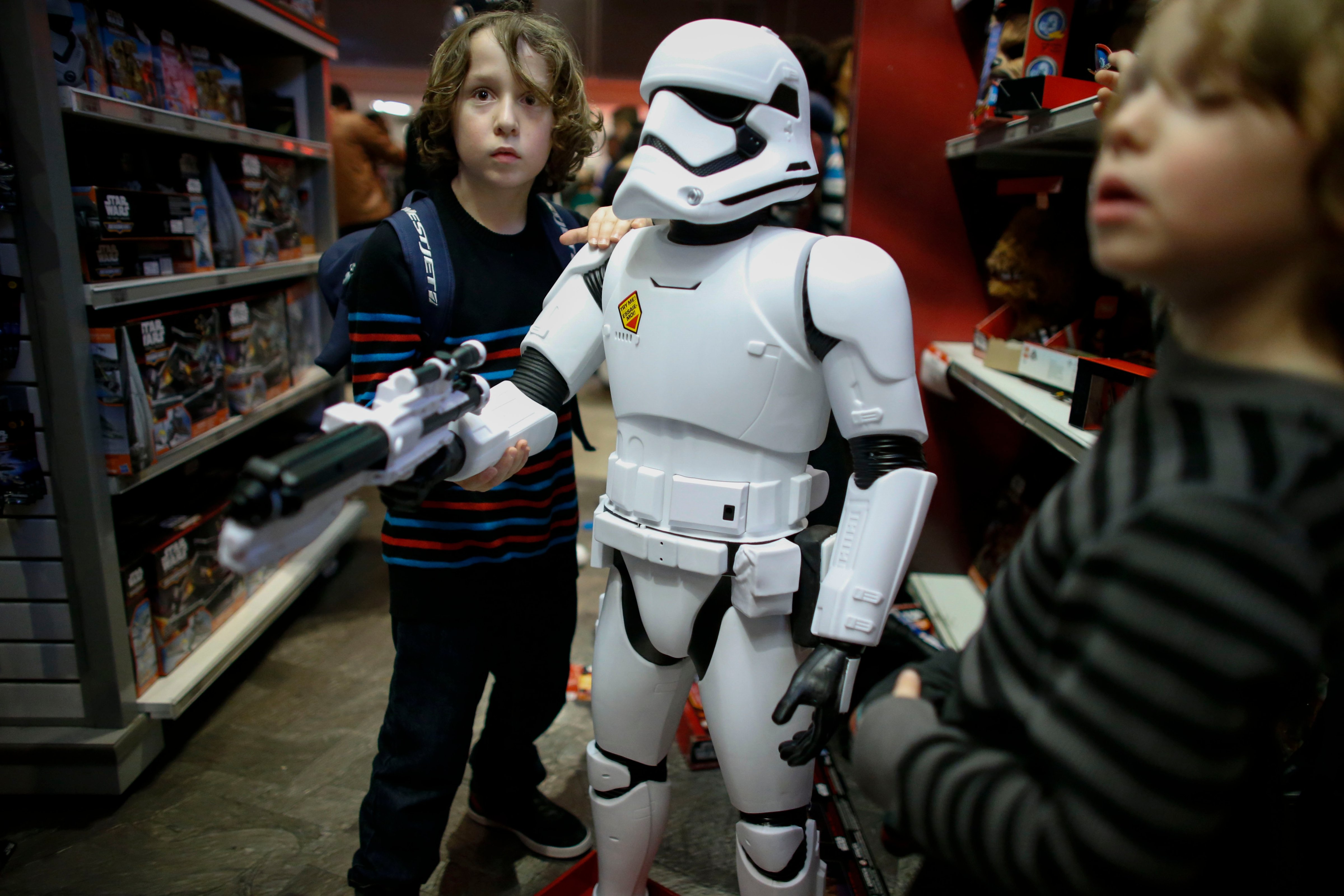 Boys play with a Stormtrooper toy from Star Wars at a Toys"R"Us store on December 24, 2015 in New York City. (Kena Betancur—Getty Images)