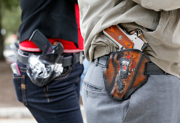 Art and Diana Ramirez of Austin with their pistols in custom-made holsters during and open carry rally at the Texas State Capitol on January 1, 2016 in Austin, Texas. (Erich Schlegel—Getty Images)