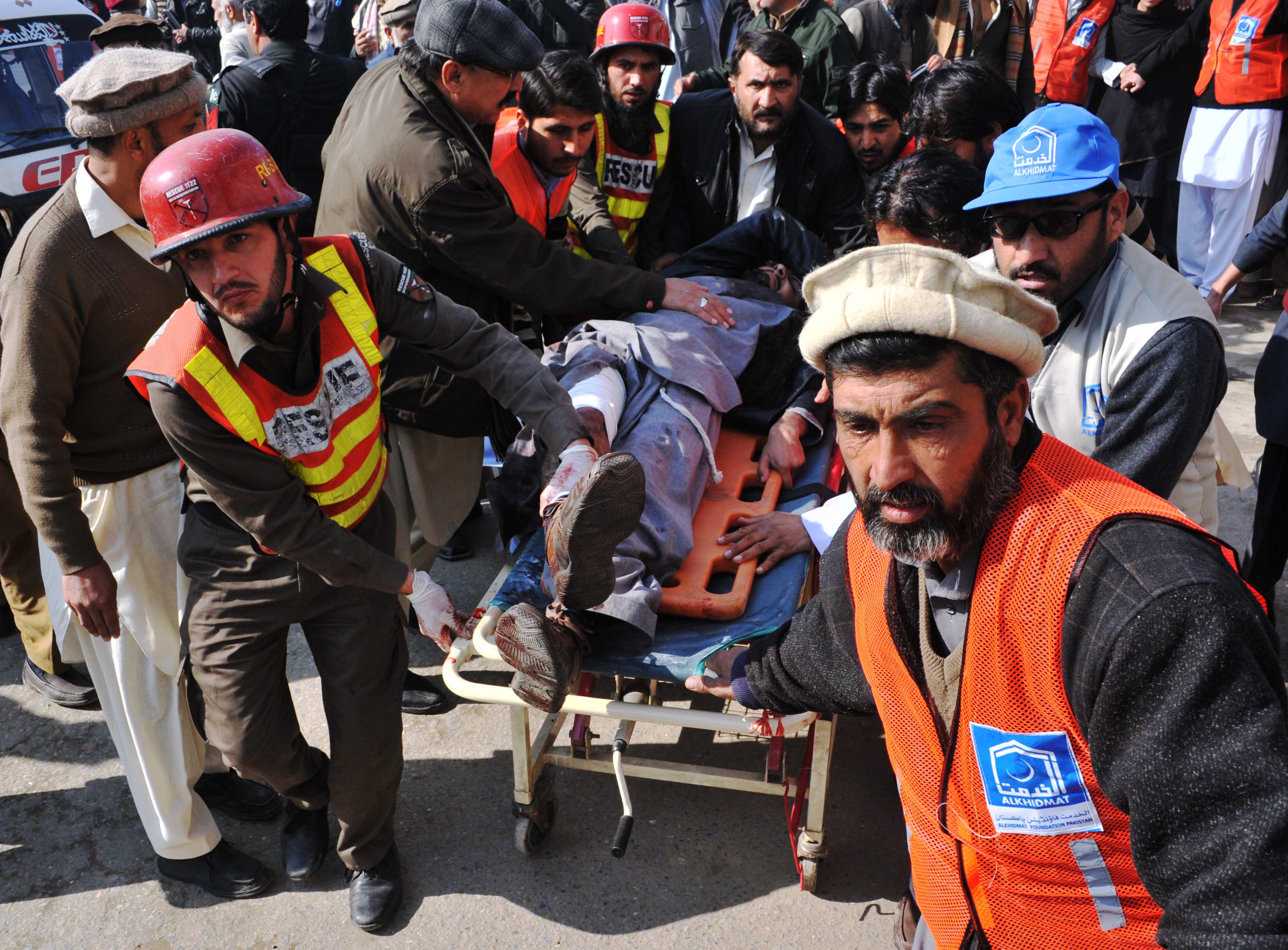 Pakistani rescuers shift an injured man to a hospital following an attack by gunmen in the Bacha Khan university in Charsadda, about 50 kilometres from Peshawar, on Jan. 20, 2016. (Hasham Ahmed—AFP/Getty Images)