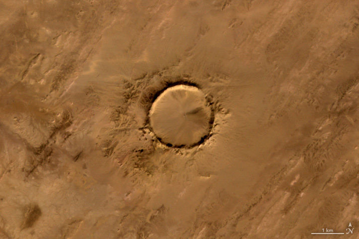 The Advanced Spaceborne Thermal Emission and Reflection Radiometer (ASTER) on the Terra satellite captured this image of Tenoumer meteorite crater in Mauritania on Jan. 24, 2008.