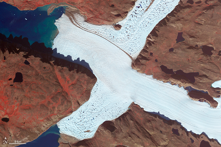 The Advanced Spaceborne Thermal Emission and Reflection Radiometer (ASTER) on NASA’s Terra satellite captured this false-color image of the northwest corner of Leidy Glacier in Greenland on August 7, 2012.