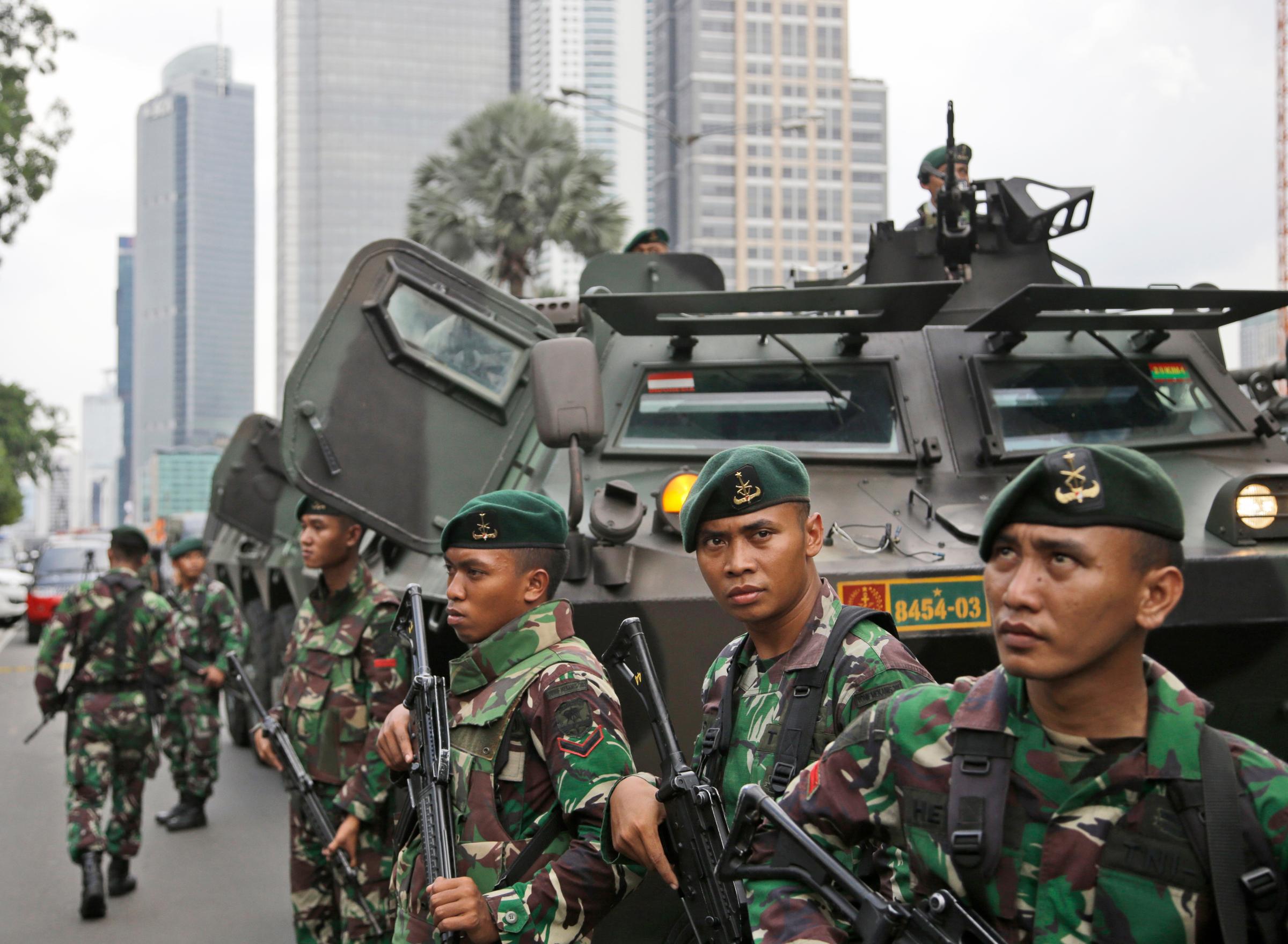 Indonesian soldiers stand guard near the site where an explosion went off in Jakarta, Indonesia, Jan. 14, 2016.