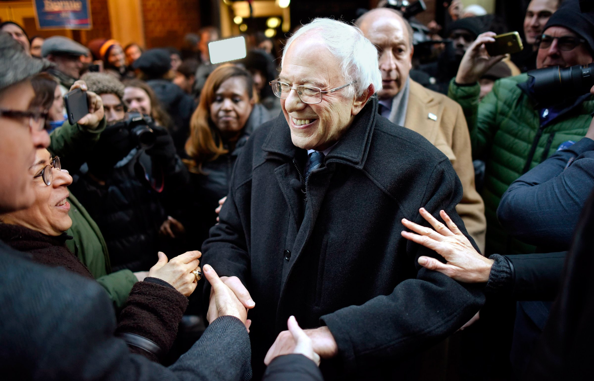 United States Democratic presidential candidate Senator Bernie Sanders (C), of Vermont, shakes hands with supporters following a speech about Wall Street and his plans for new financial regulations at Town Hall in New York, New York, USA, 05 January 2016.